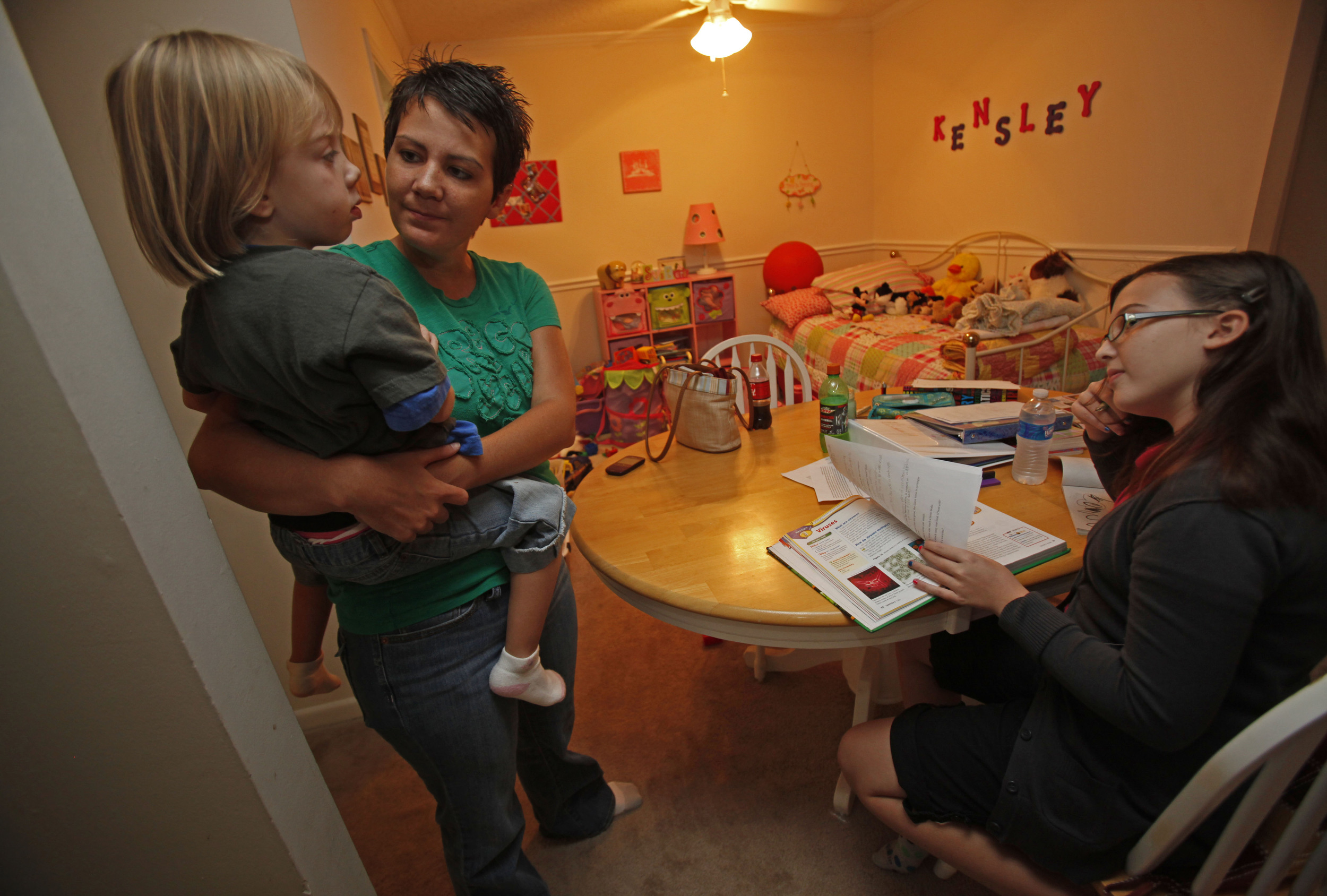  Lori Harrington and daughters Jasey, 12, and Kensley, 4, spend evenings around the kitchen table in their small apartment September 8, 2010 in Nashville, Tenn. Harrington moved to an apartment and left her job due to the stress of recovering from th