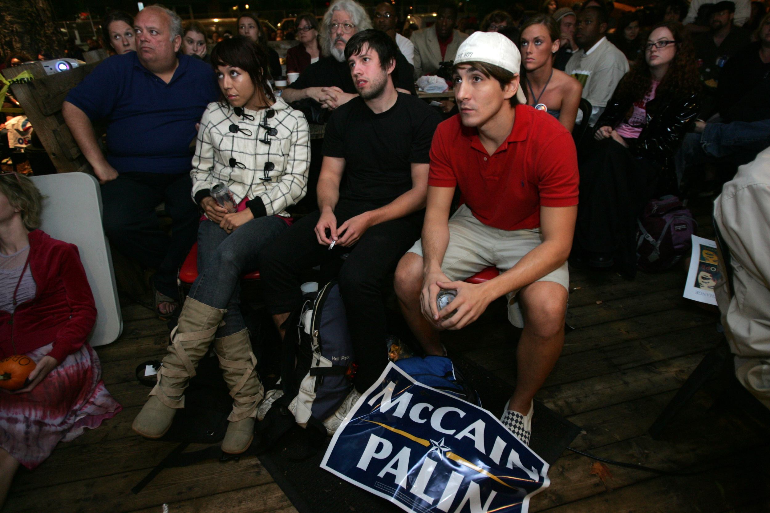  Jack Young with a McCain sign at his feet watches the beginning of the town hall debate on TV at nearby Bongo Java coffee shop. 