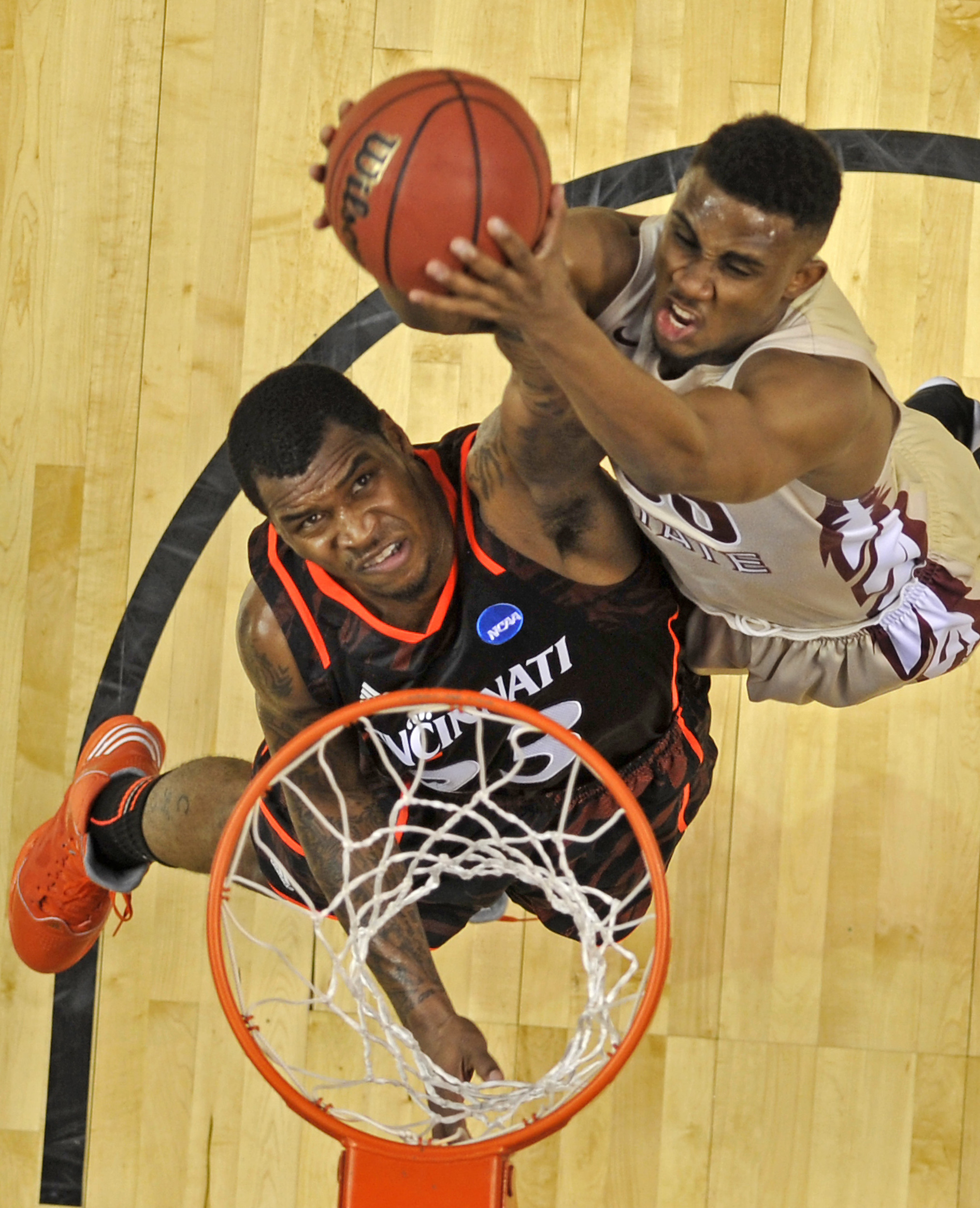  Cincinnati guard Sean Kilpatrick (23) fights for a rebound with Florida State guard Ian Miller during the first half of the NCAA Men's Third Rounds at Bridgestone Arena in Nashville, Tenn., Sunday, March 18, 2012.  