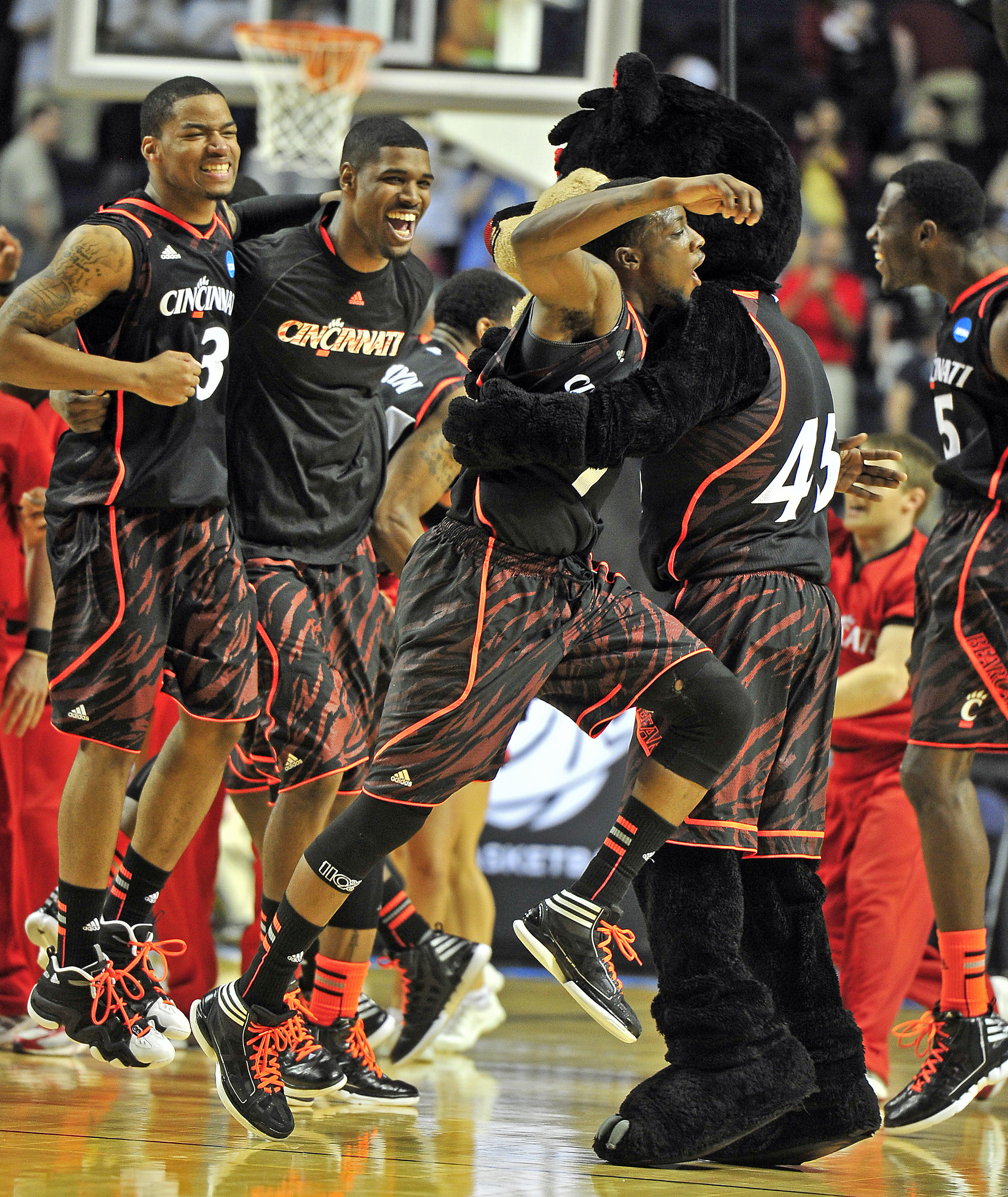  Cincinnati guard Cashmere Wright (1) jumps into arms of a Cincinnati mascot as they celebrate a 62-56 win over Florida State during the NCAA Men's Third Rounds at Bridgestone Arena Sunday, March 18, 2012 in Nashville, Tenn. 