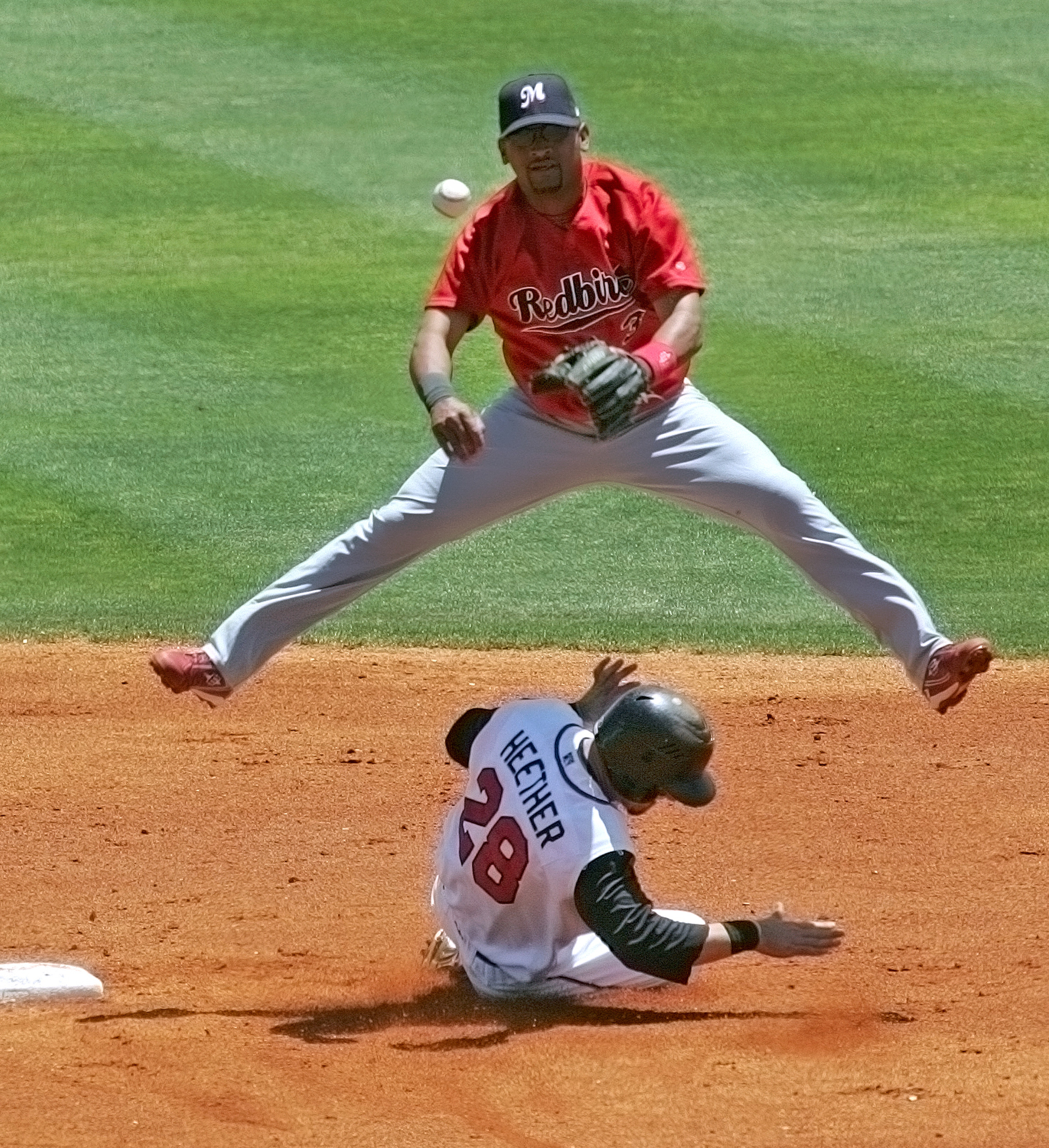  Memphis Redbirds shortstop D'Angelo Jiminez (3) throws to first for a double play and leaps over The Sounds' Adam Heether (28) as he slides into second May 21, 2008 in Nashville, Tenn. 