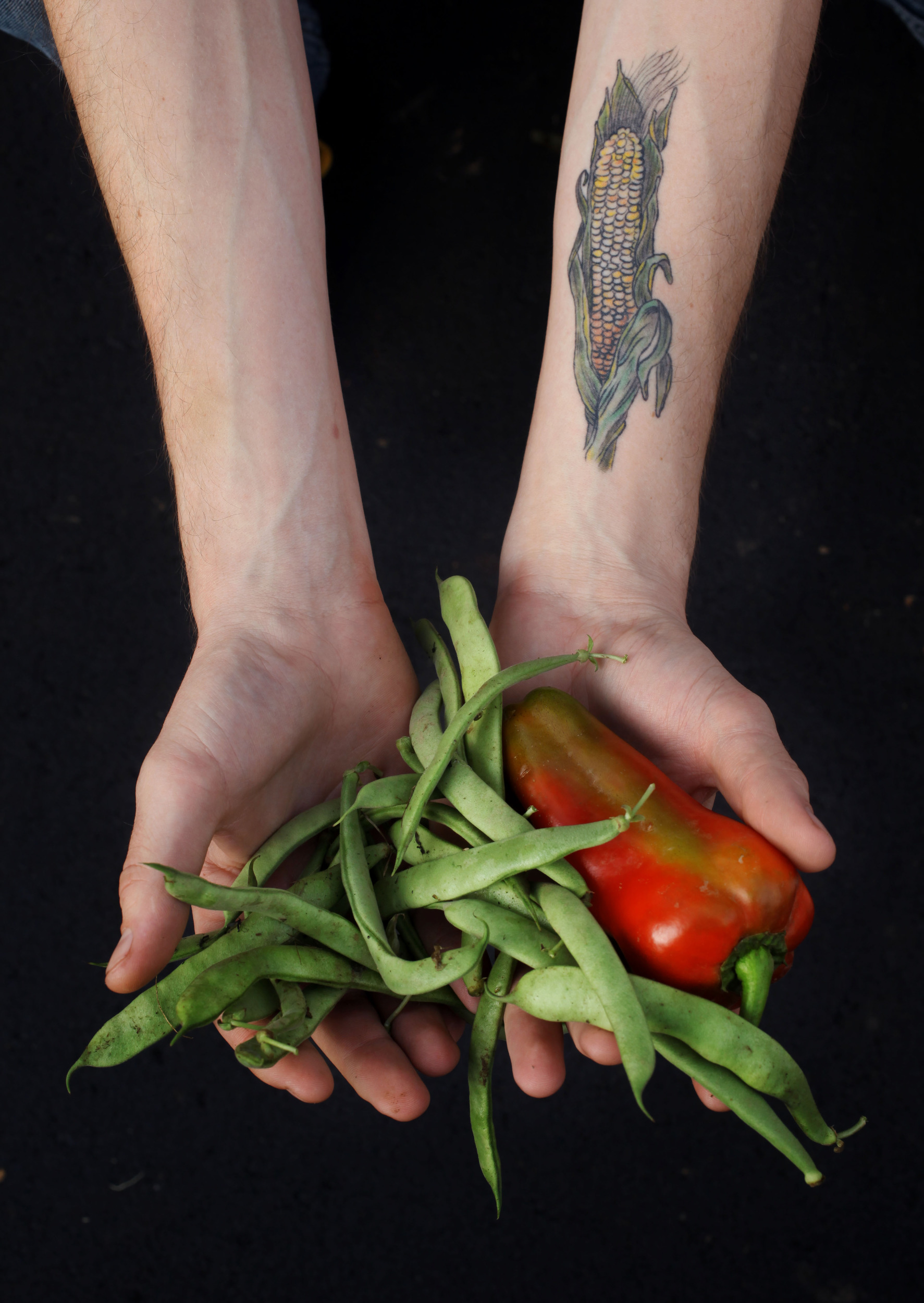  Self-described foodie Andy Brubaker displays the cornstalk tattoo on his forearm at the East Nashville Farmers market. 