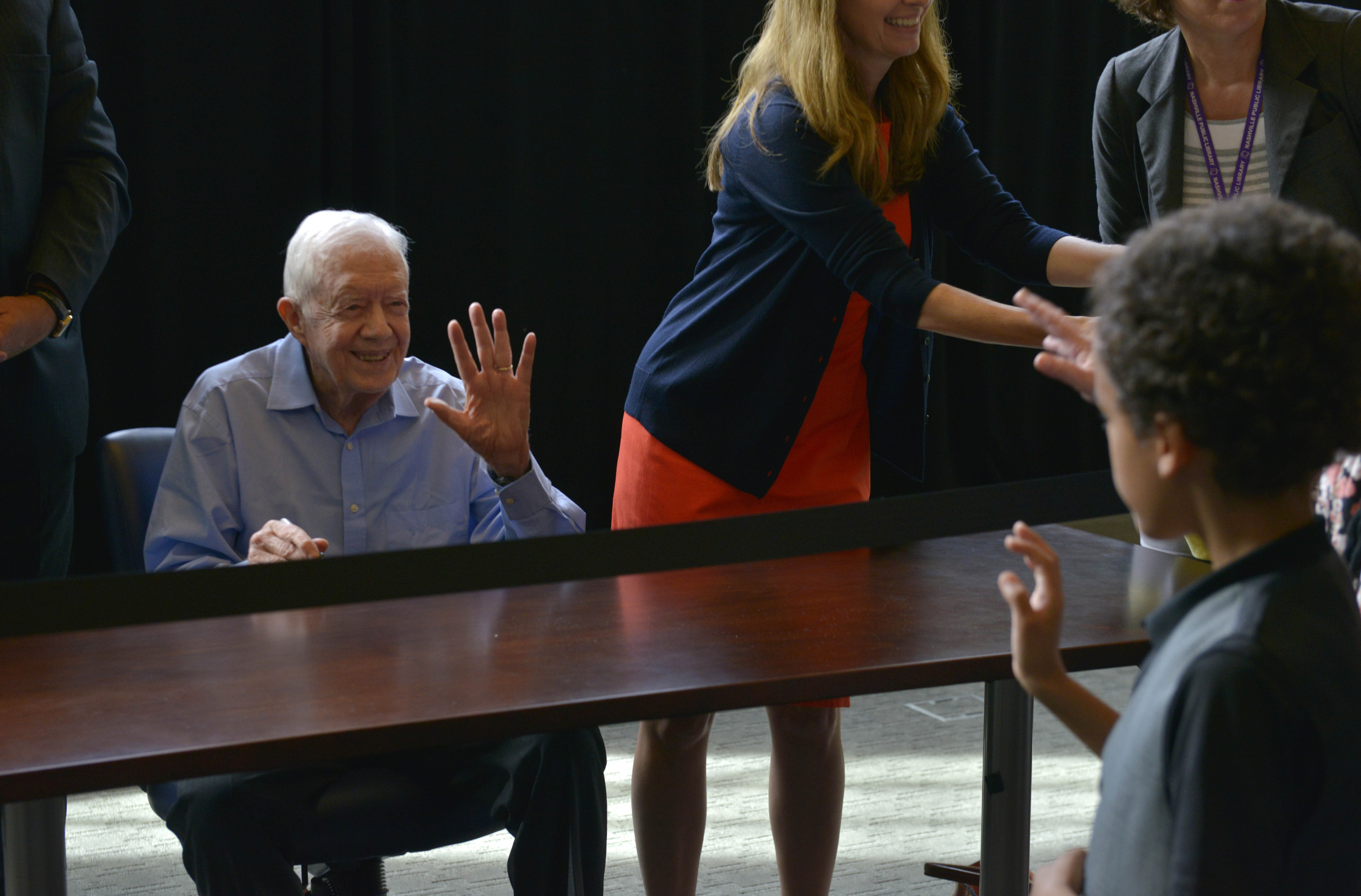  Former President Jimmy Carter waves to a young boy as he does a book signing at the downtown branch of the Nashville Public Library July 23, 2015 in Nashville, Tenn. 