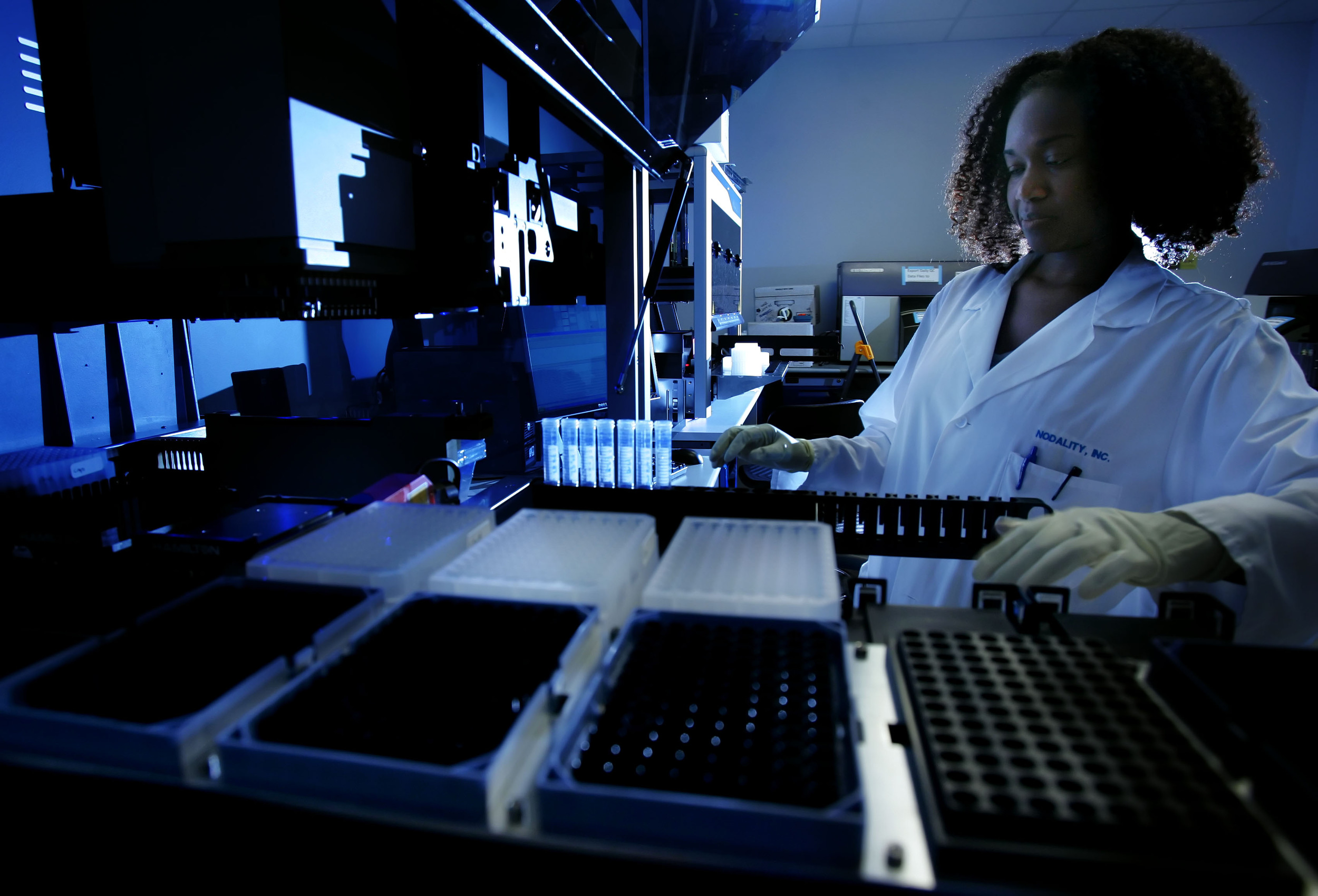  Research associate Danyel Specht places cancer patient samples into a robotic machine to determine molecular patterns that will help oncologists make treatment decisions at Nodality Inc. in Nashville, Tenn.  