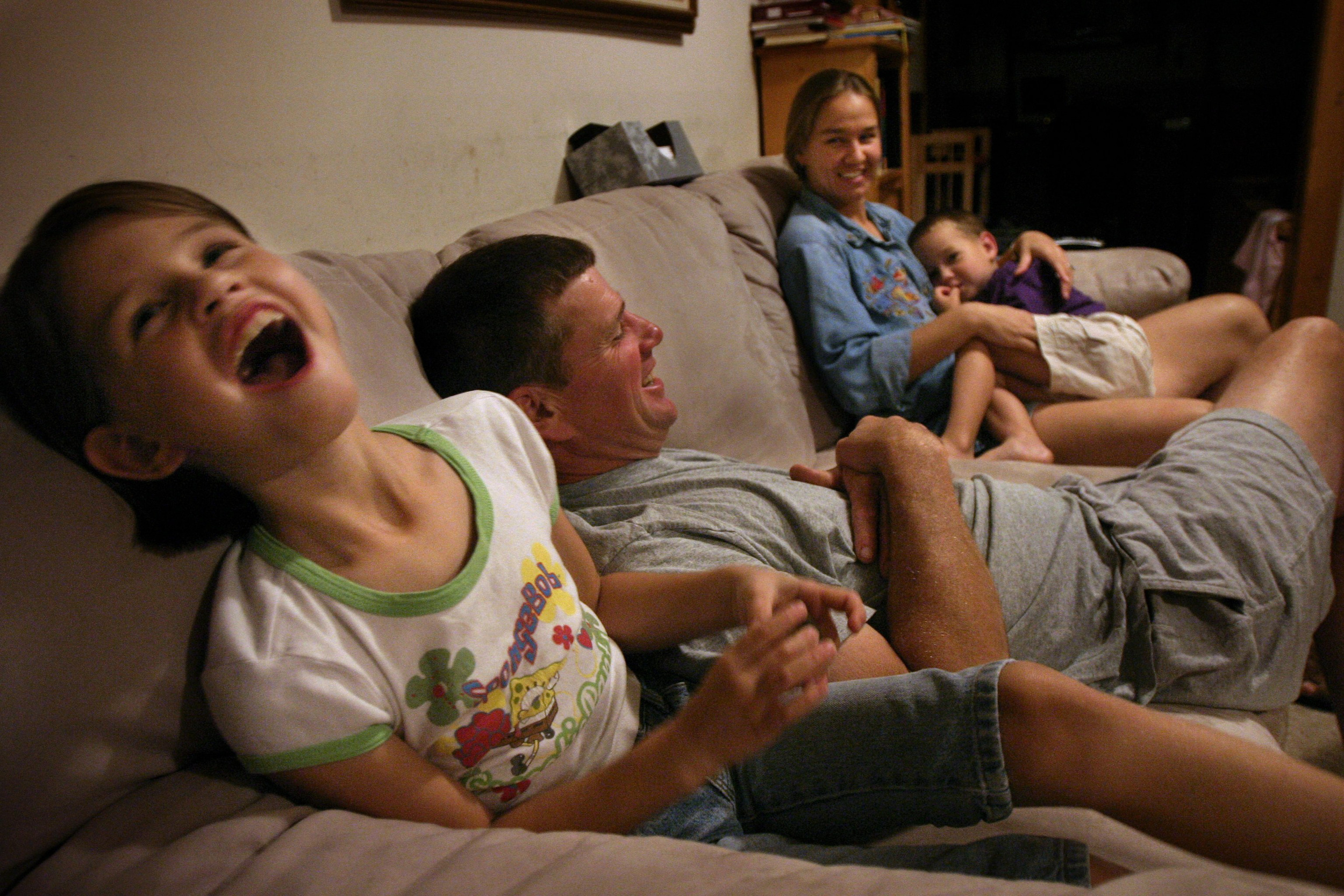Anna Stewart Burdette laughs at a story about her little brother as a child during an evening before bedtime. Ilona Burdette said that some of their favorite times of the day are in the evening, talking and laughing.