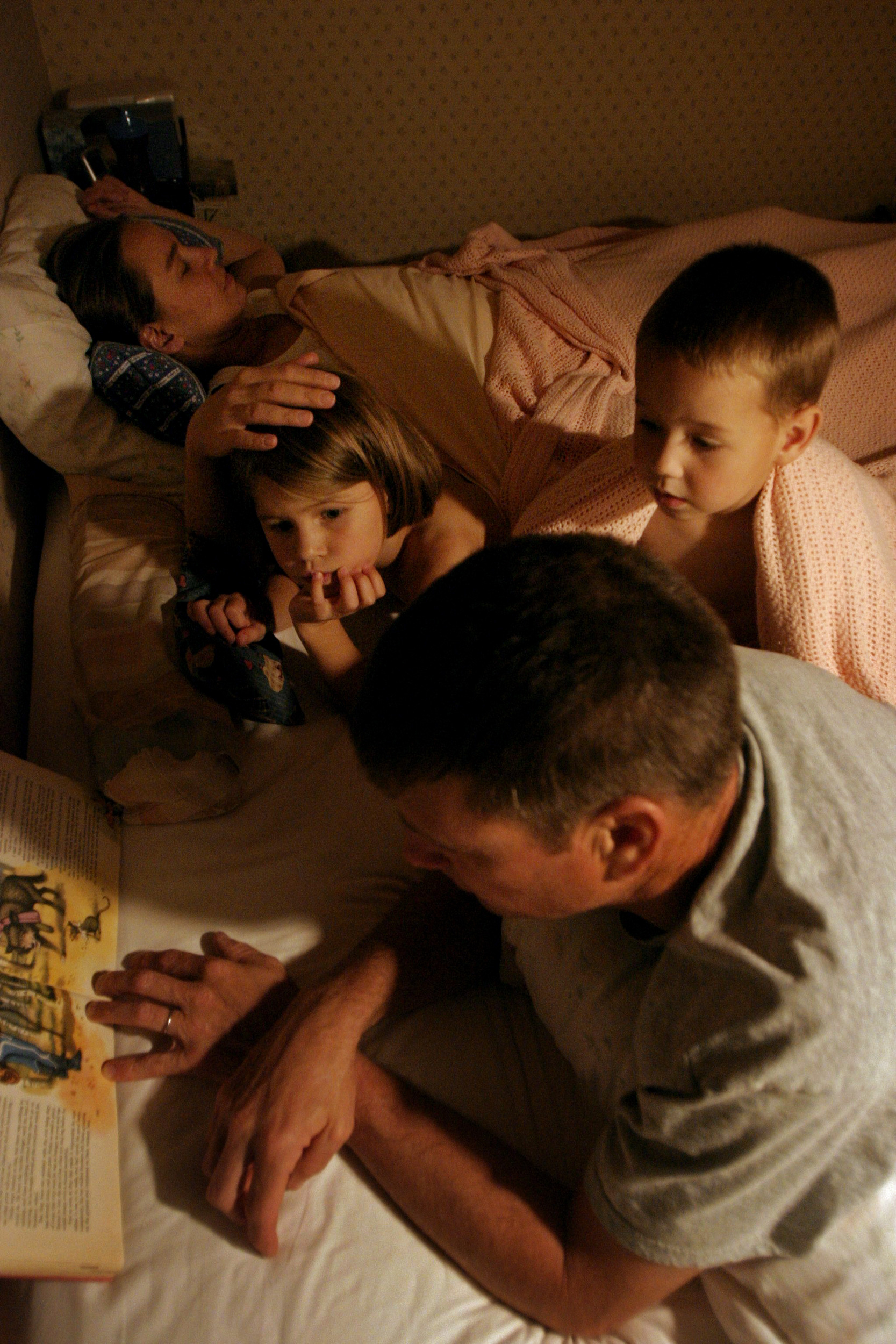  Pat Burdette reads to the children at bedtime as they fall asleep together. 