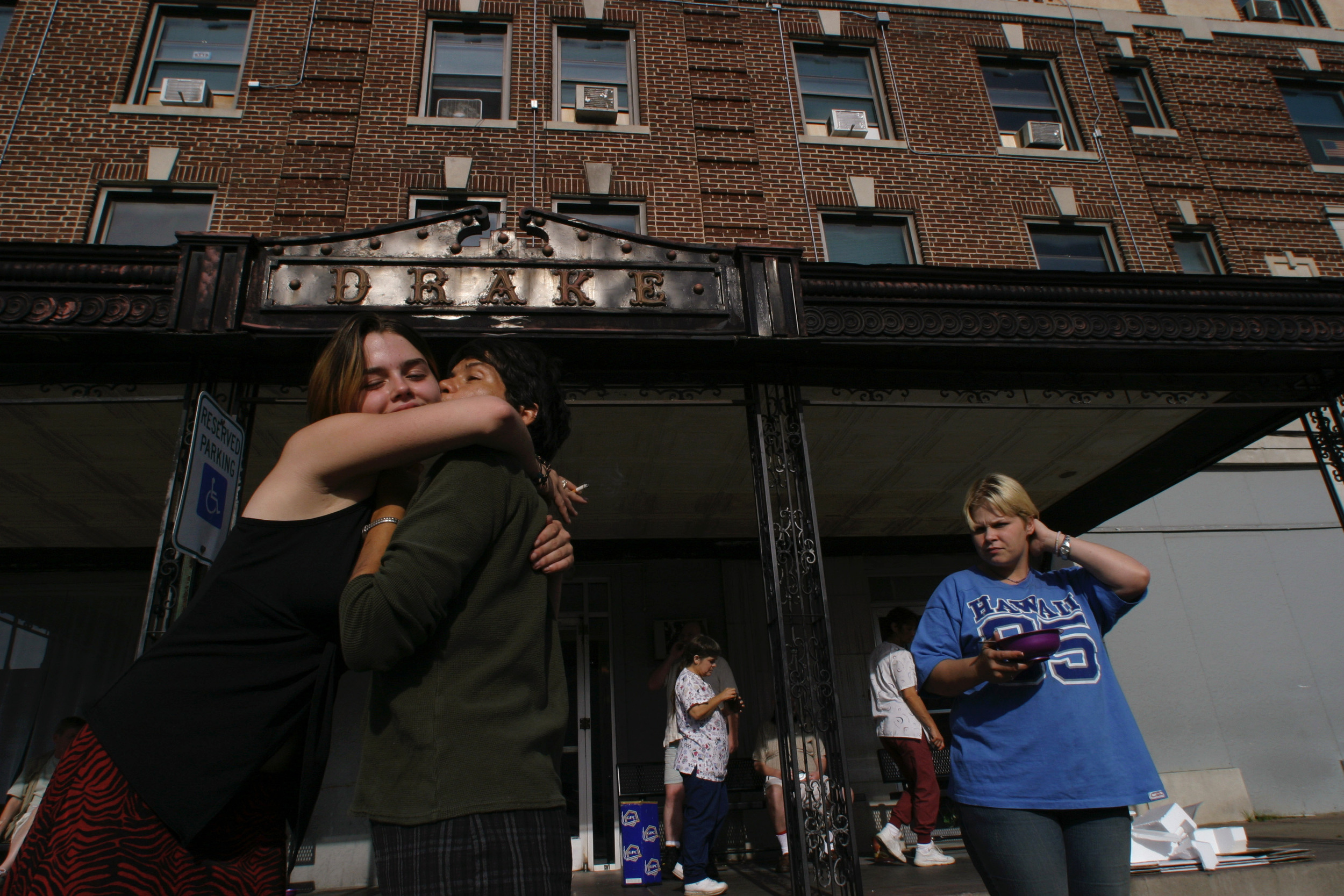  Keesha Gilleland , 16, hugs Toni, at the Drake guesthouse, formerly an upscale hotel in downtown Carthage, Missouri, now a group home for the mentally and physically disabled. 