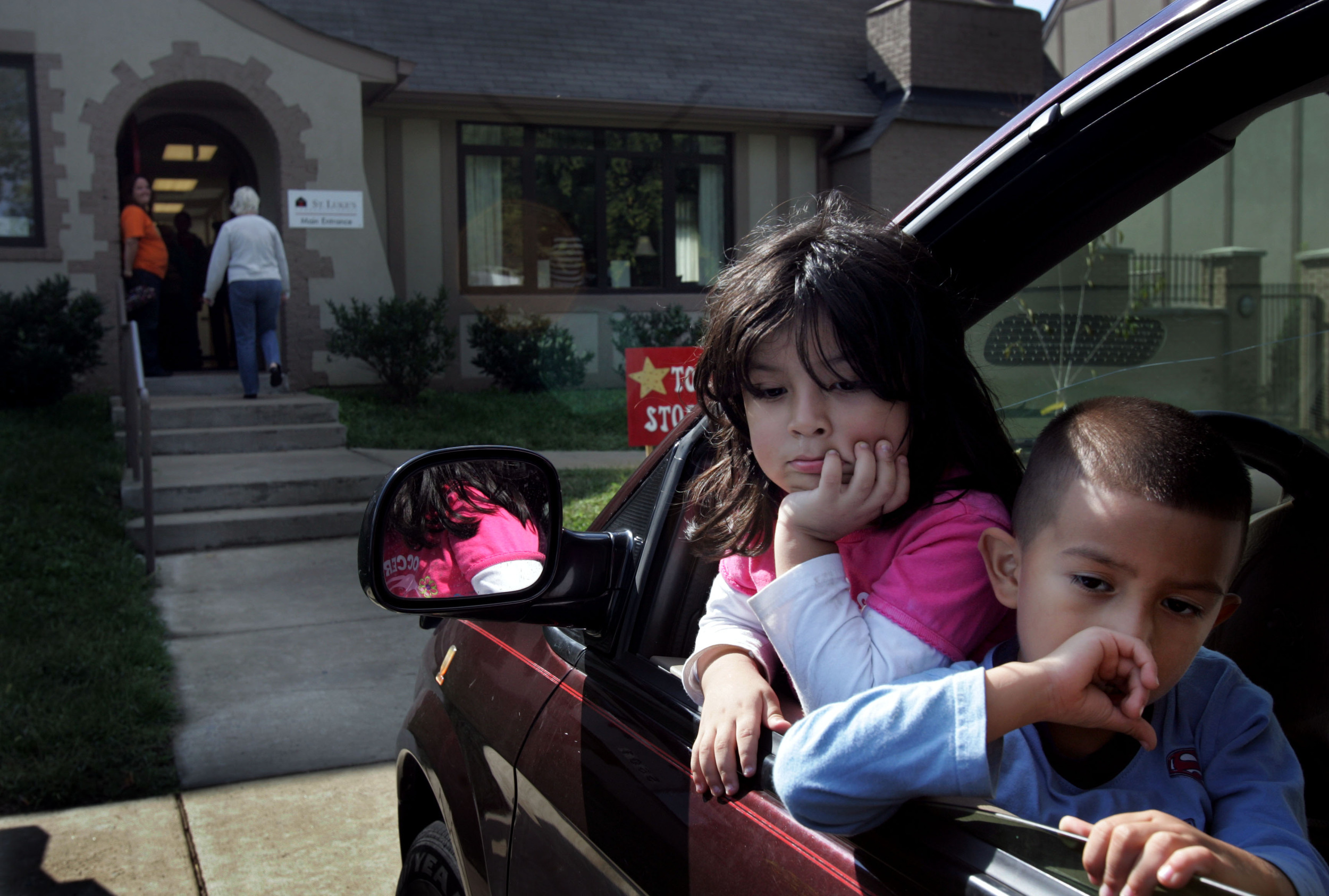  Natalie Hernandez, 3, with cousin Renee Cordero, wait in the car at St. Luke's Community House for their parents to pick up from the food bank in Nashville, Tenn. 