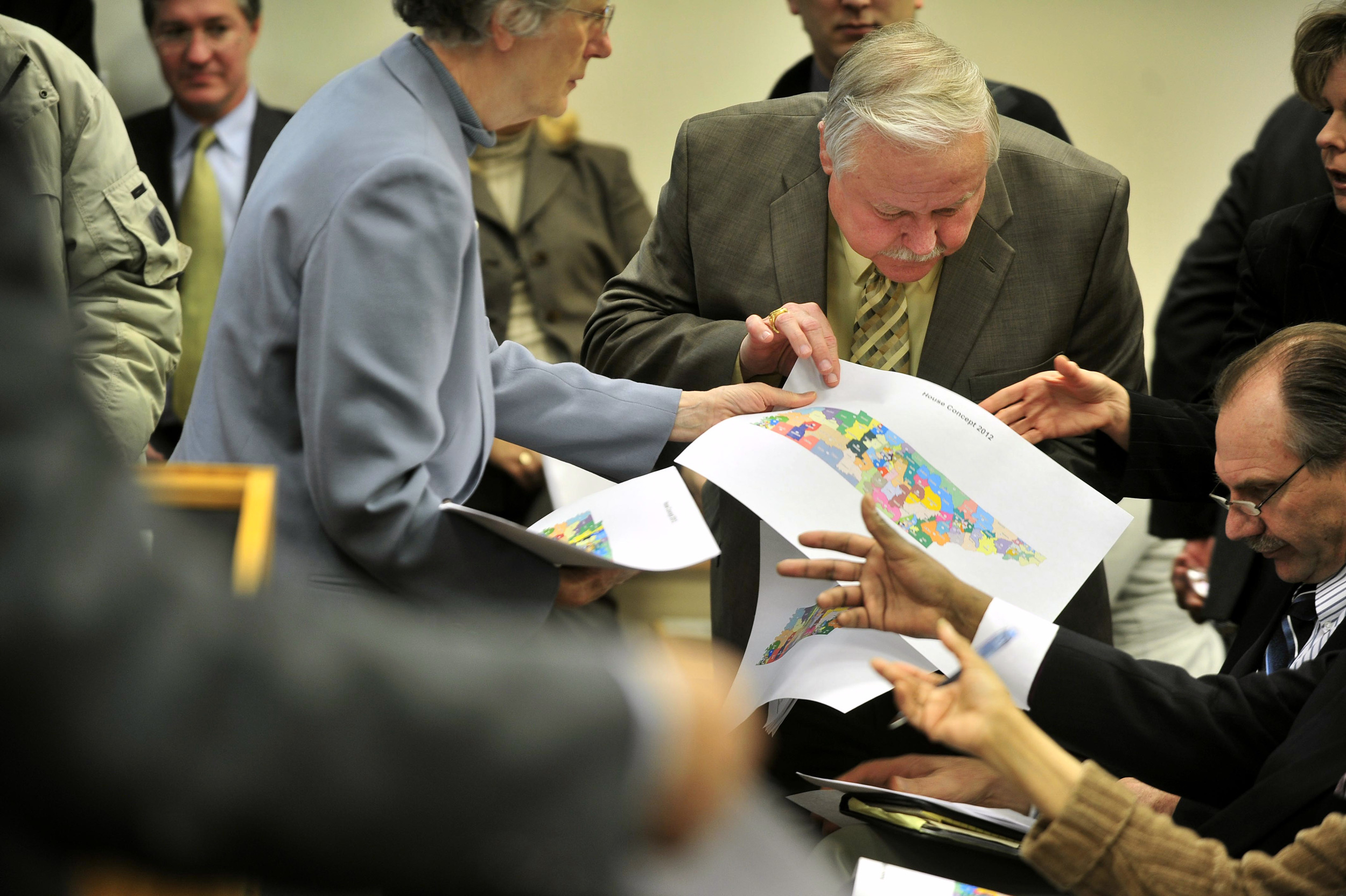  Attorney Sally Swaney hands out redistricting maps to a crowd of lawmakers including Rep. Gary Moore D-Joelton, and Rep. Mark Pody R-Lebanon, right. The map was a controversial plan proposed by Republican lawmakers January 4, 2012 Nashville, Tenn. 