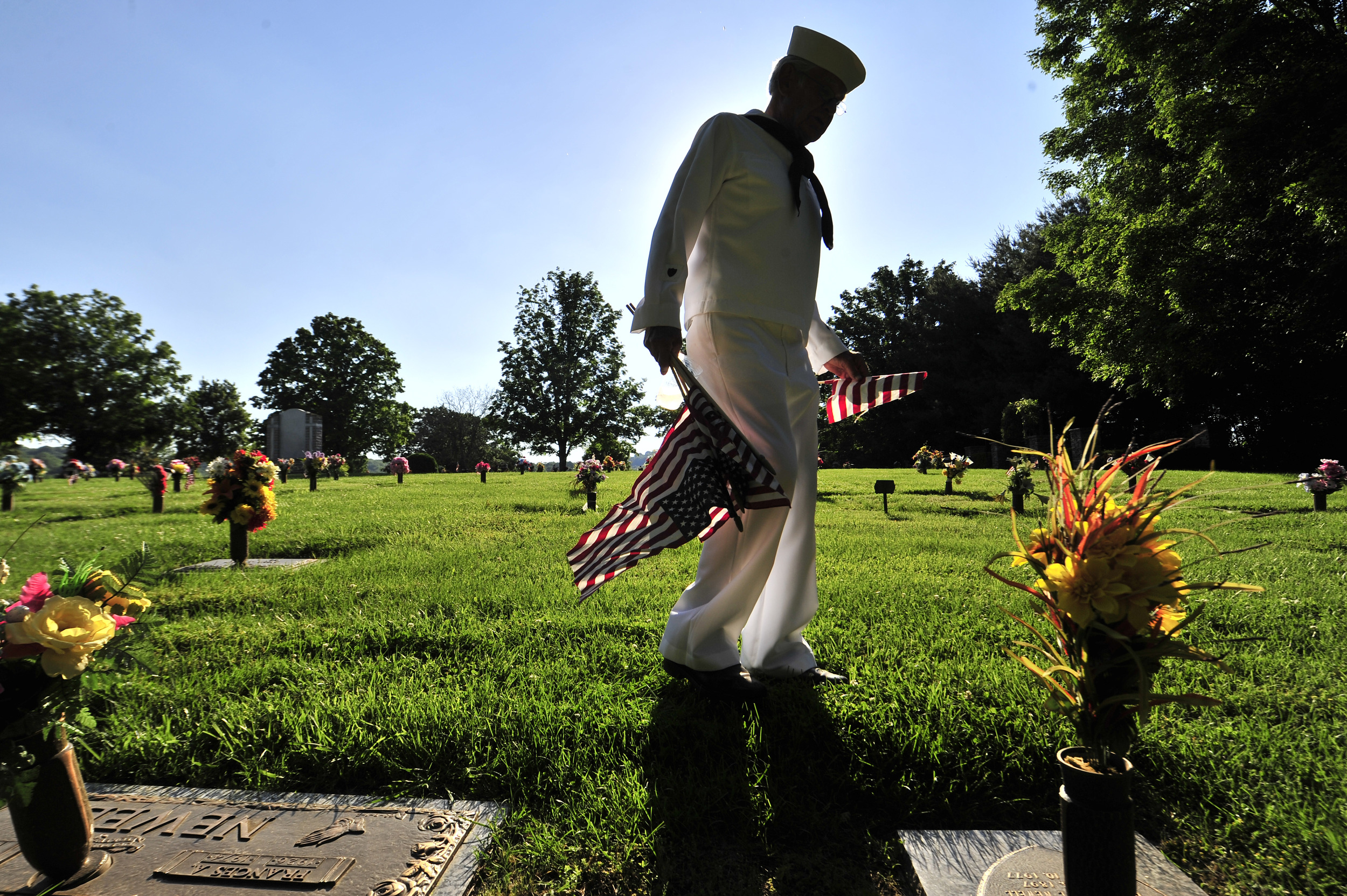  Coast Guard veteran Marty Gencsi plants flags on the graves of veterans at Williamson Memorial Garden Friday, May 24, 2013 in Franklin, Tenn. 