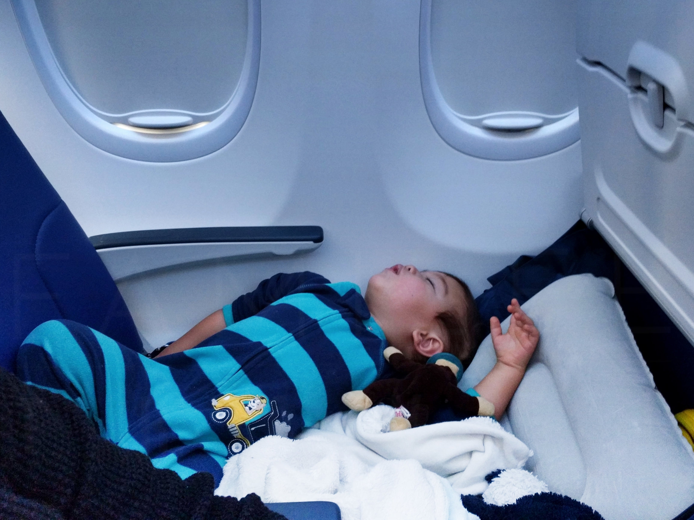 Elden (22 months old) using Fly LegsUp to sleep on the plane