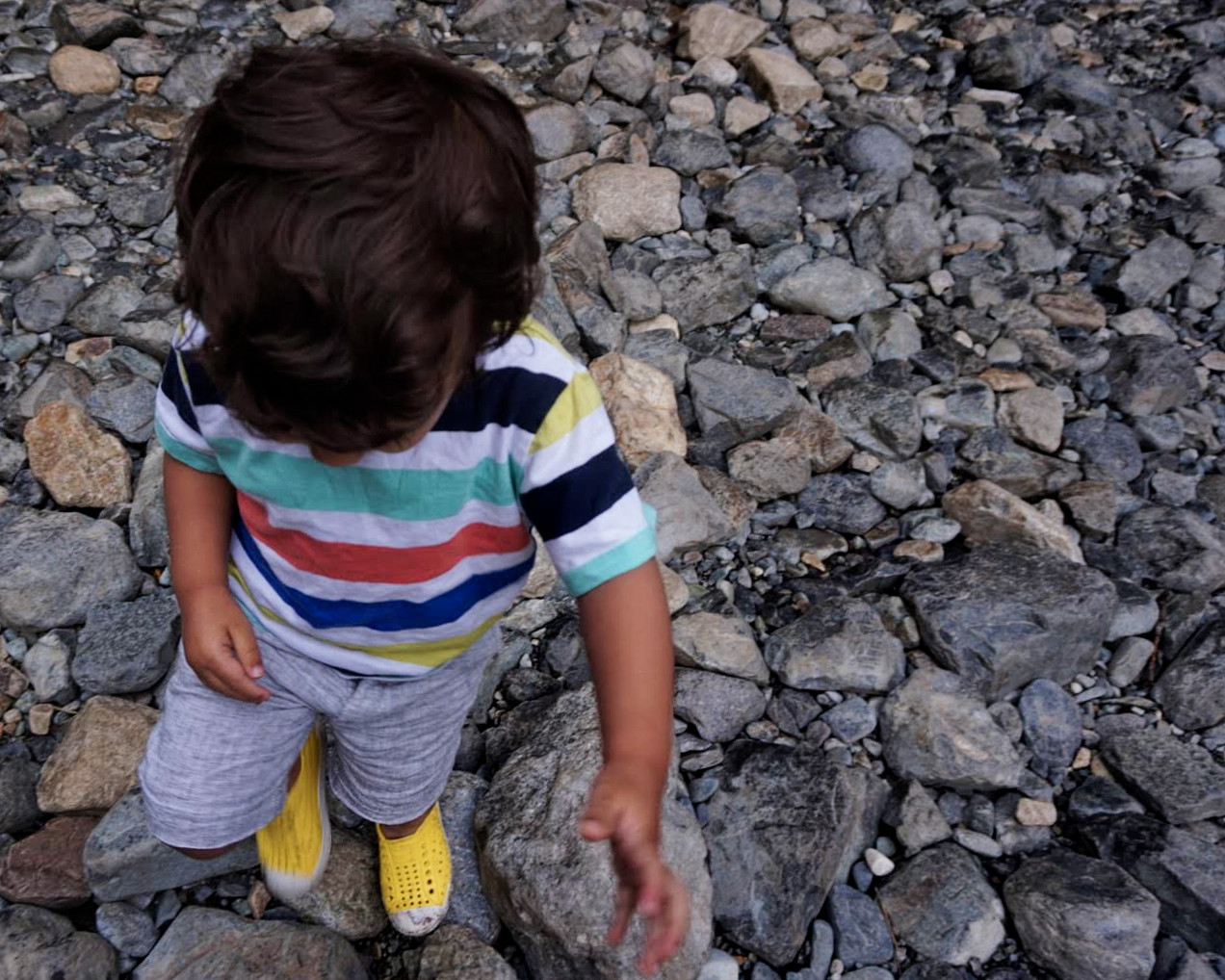 Elden (2 years old) playing with rocks near the waterfall 