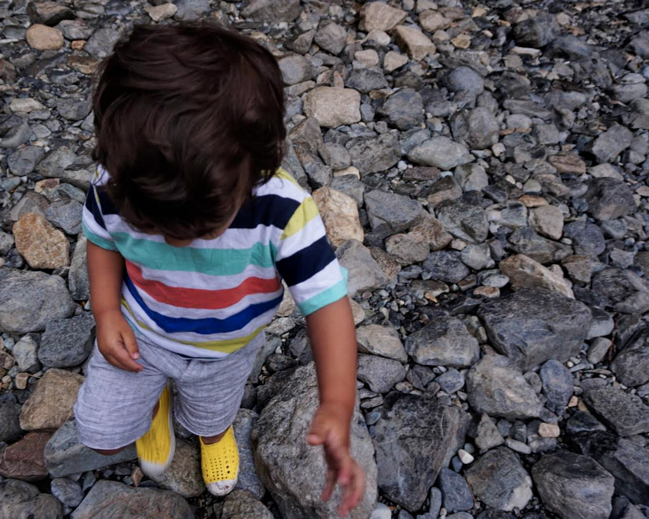 Elden (2 years old) playing with rocks near the waterfall