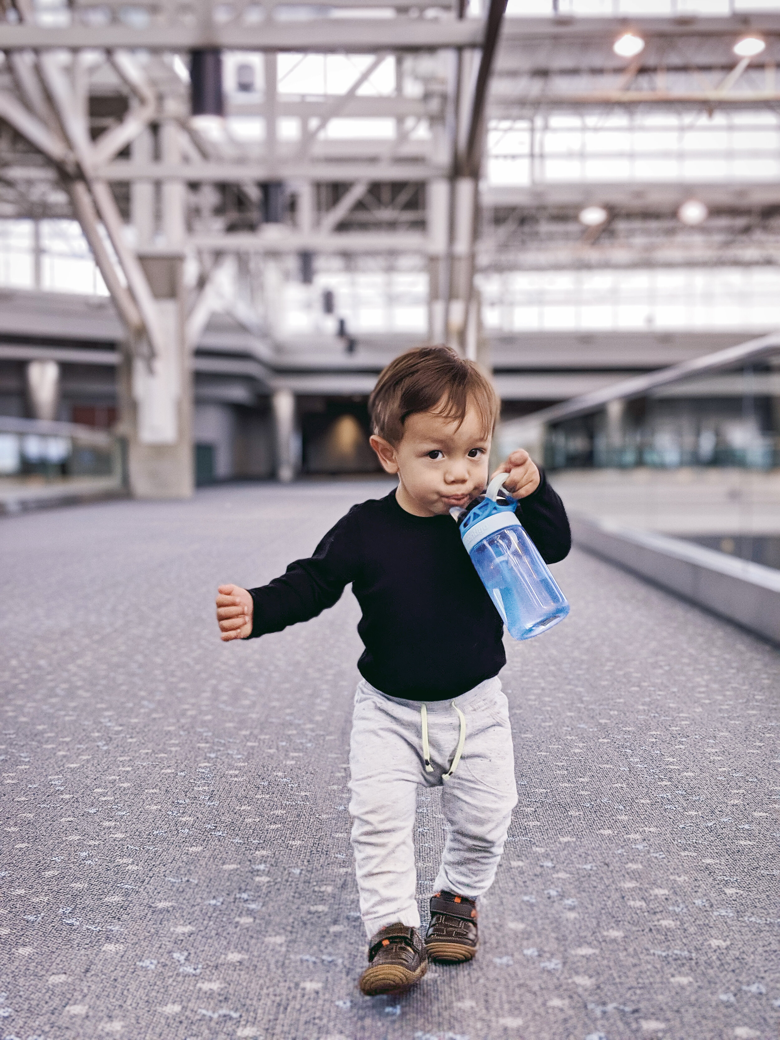 FAMILEE Travel_baby toddler drinking from water bottle at Denver airport.jpg