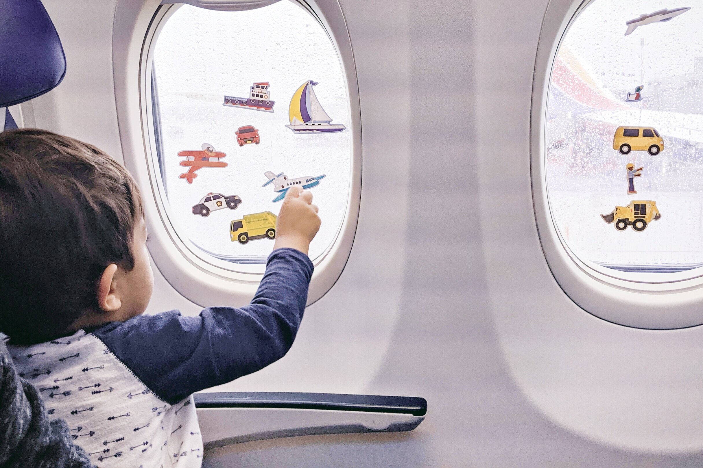  Elden playing with reusable stickers on the plane windows, grab a lucky row like this with two windows if you bring this activity 