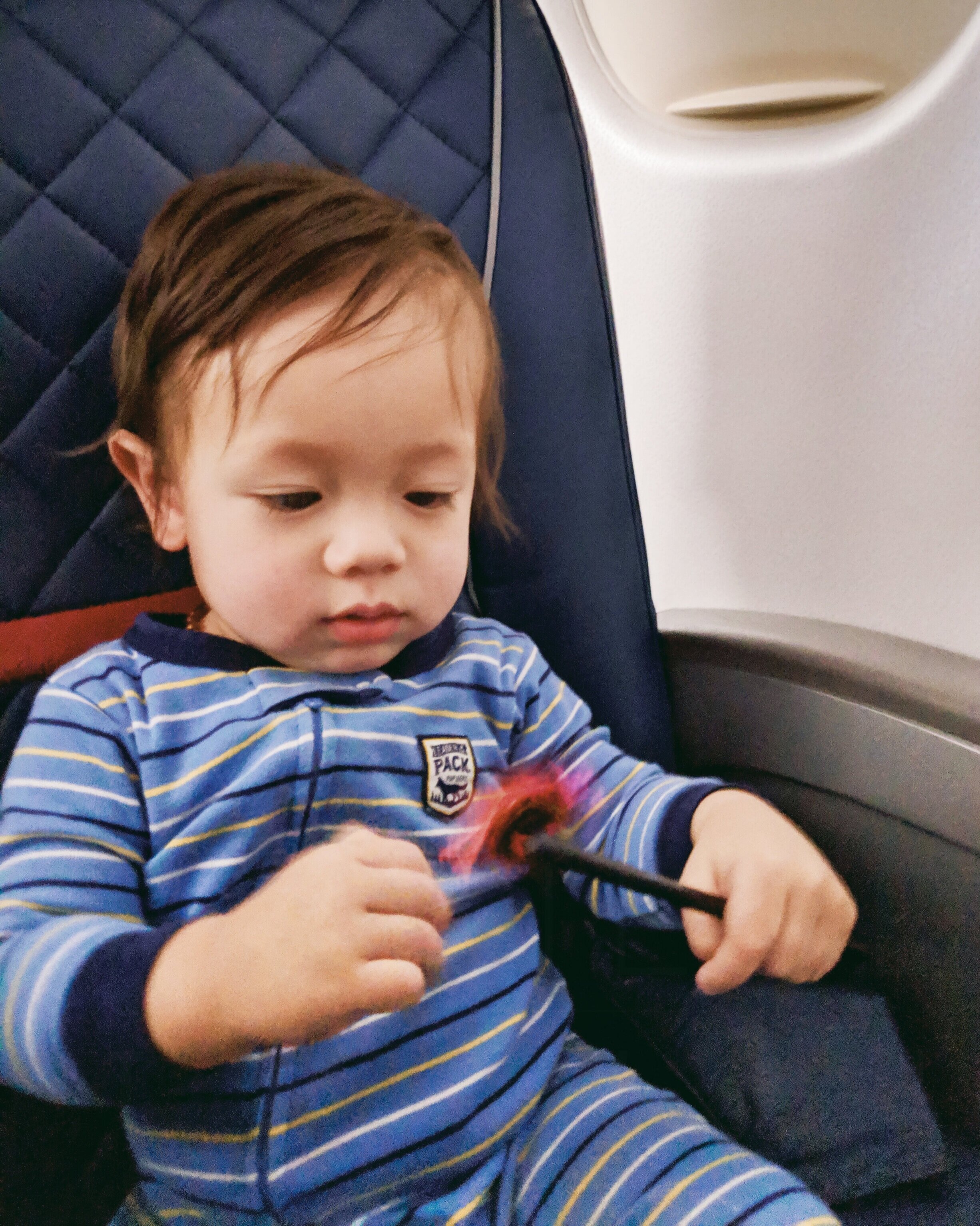  Orlo playing with a pinwheel from the Travel Toyz pack for an entire flight 