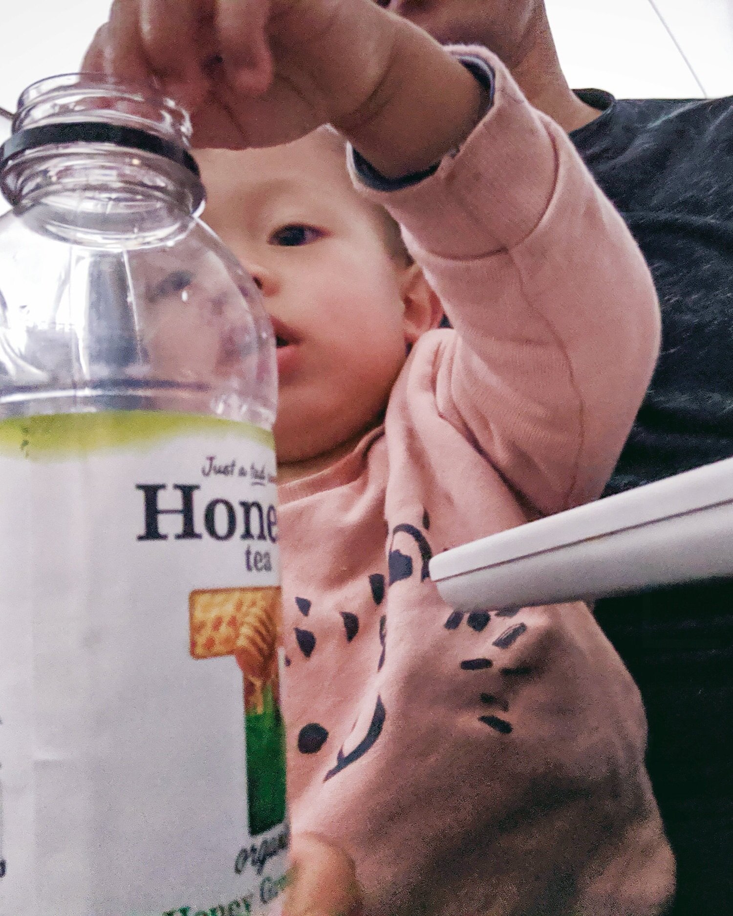  Orlo playing with a cup of ice and empty bottle 