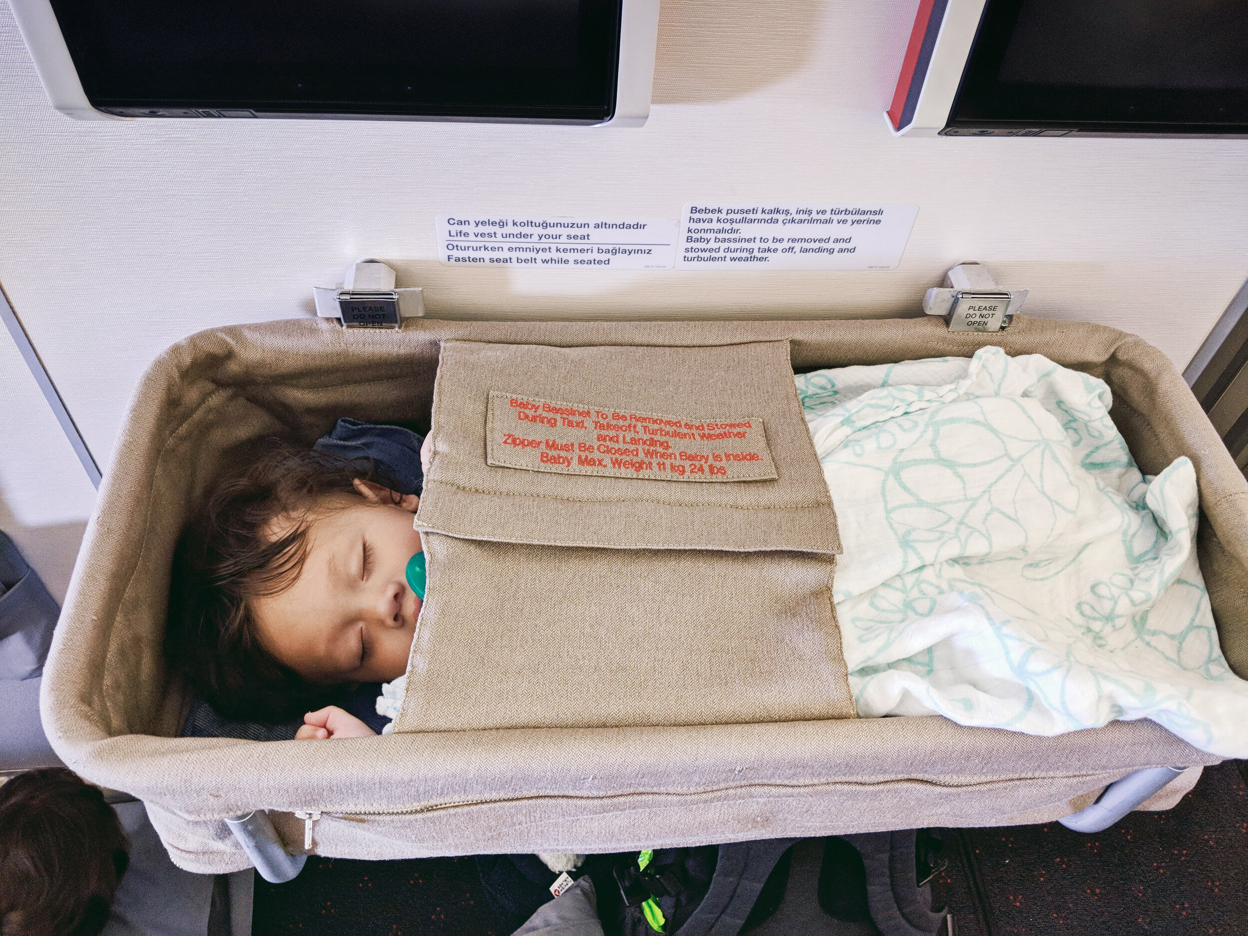  Orlo (6 months old) sleeping in airplane baby bassinet on Turkish Airlines 