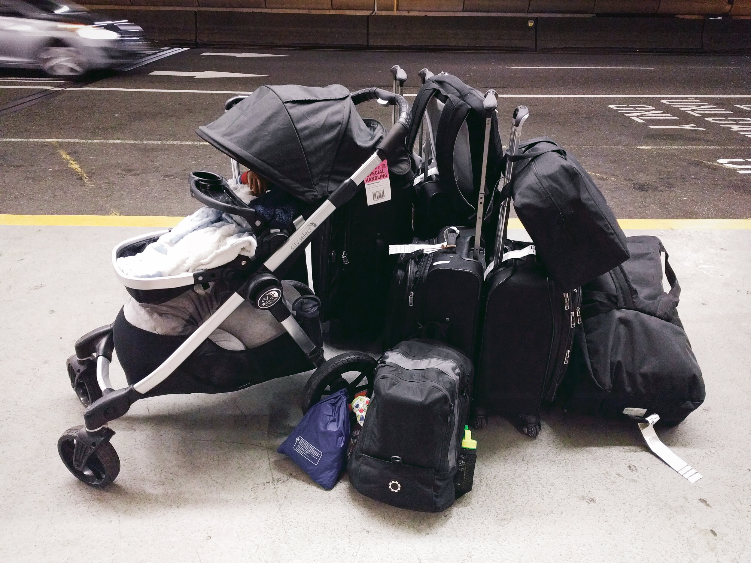 The opposite of packing minimally, what it looks like when you move cross country with a baby (Pictured: Travelpro suitcases, DadGear diaper backpack, J.L. Childress car seat bag, Lotus travel crib and more)