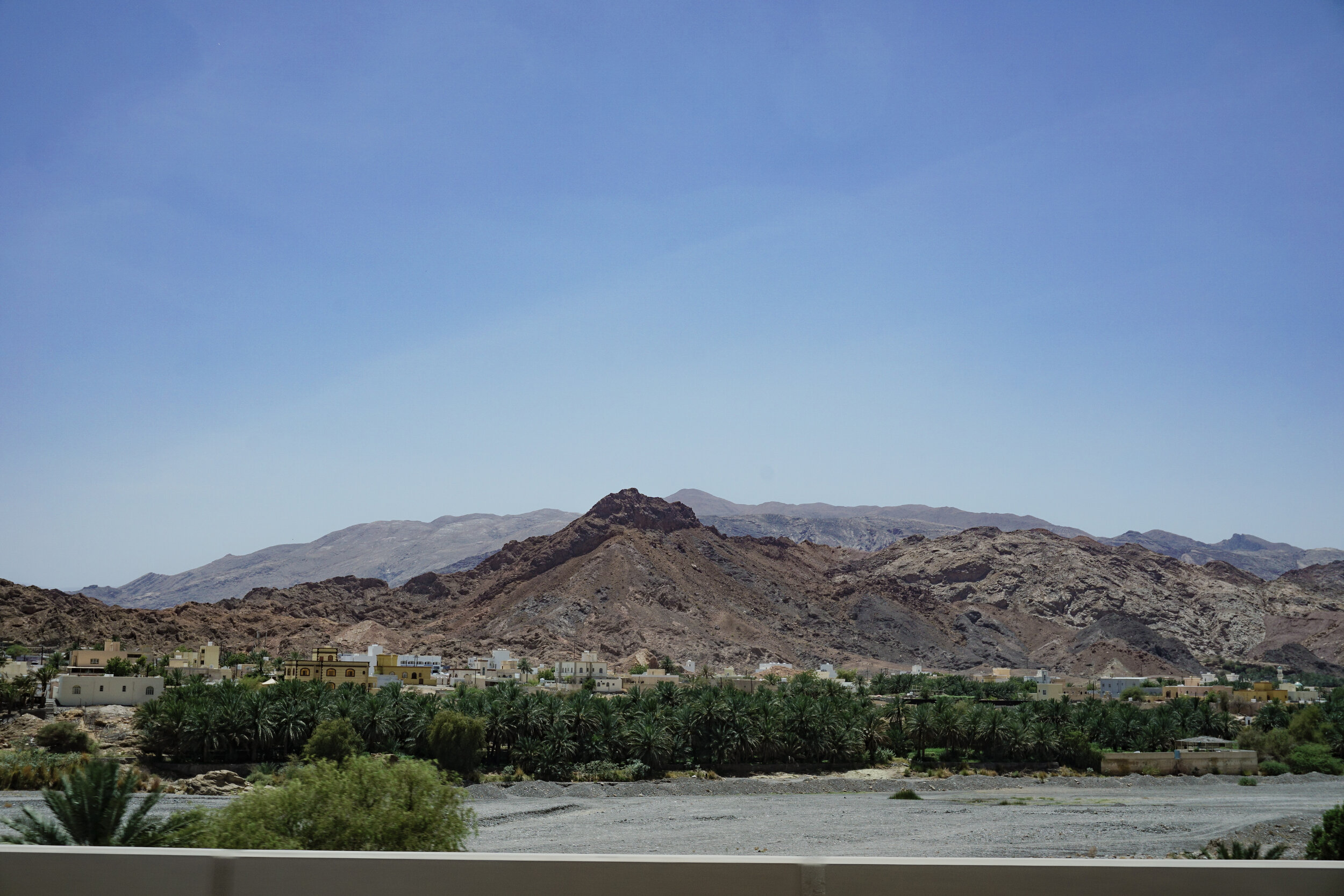 Omani-houses-among-palm-trees-and-rocky-mountains.jpg