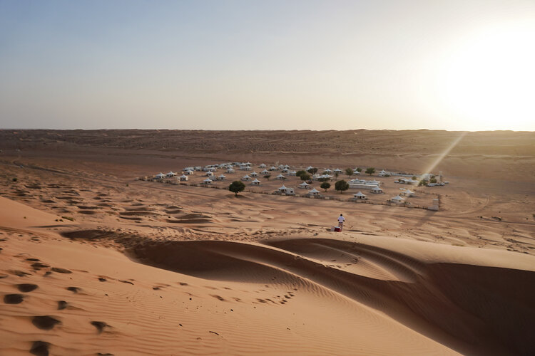 Sunset-from-desert-dunes-overlooking-Desert-Nights-Camp-Oman-Wahiba-Sands.jpg