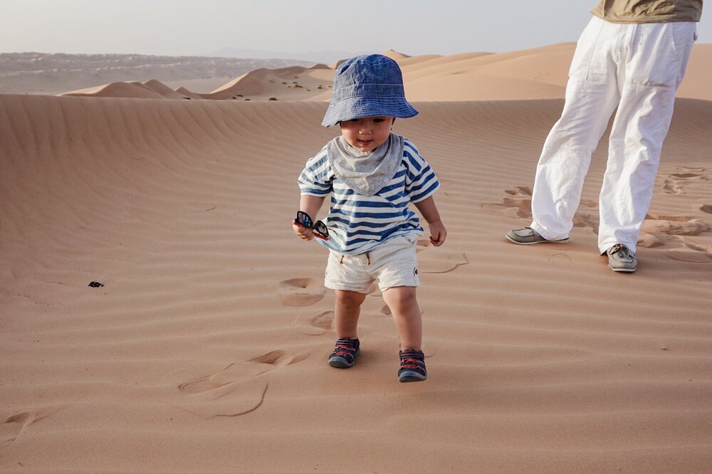 New-walking-toddler-desert-dunes-Oman-Wahiba-Sands.jpg