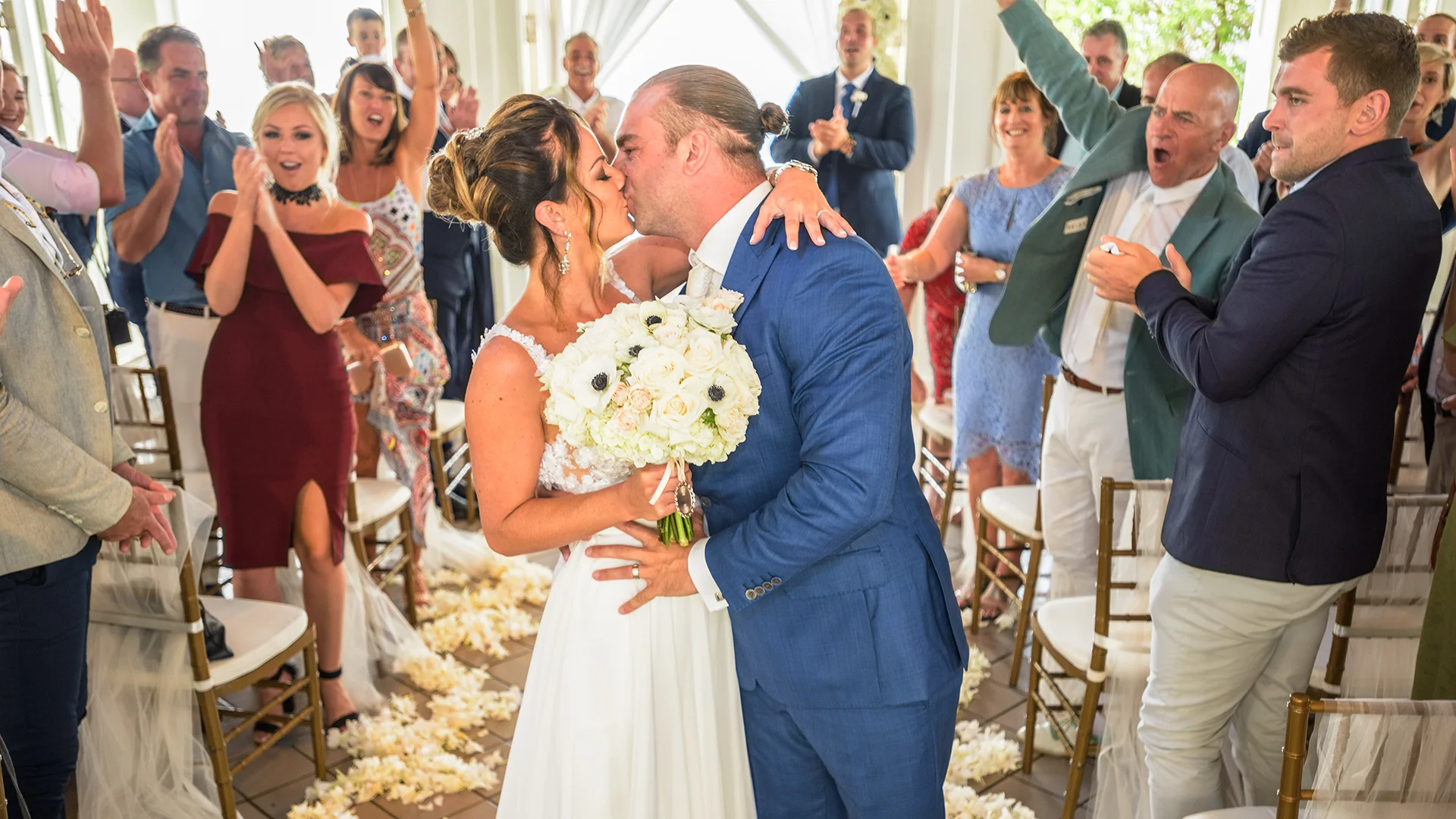 Guests of the bride and groom congratulate them after tying the knot at the Turtle Bay Resort on the North Shore of Hawaii.