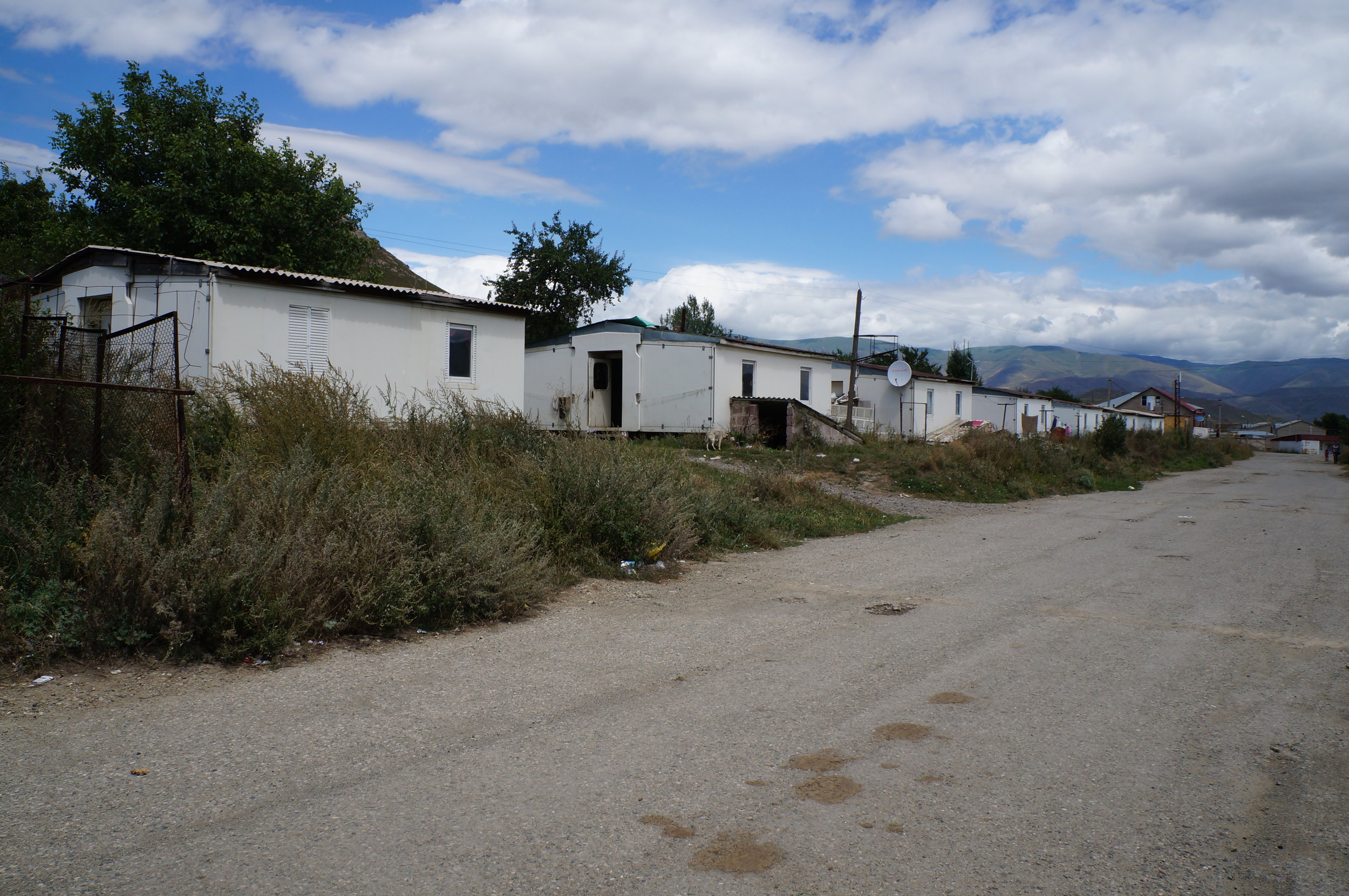 A line of Italian-constructed domiks (small, temporary houses) where families still live in Spitak. 