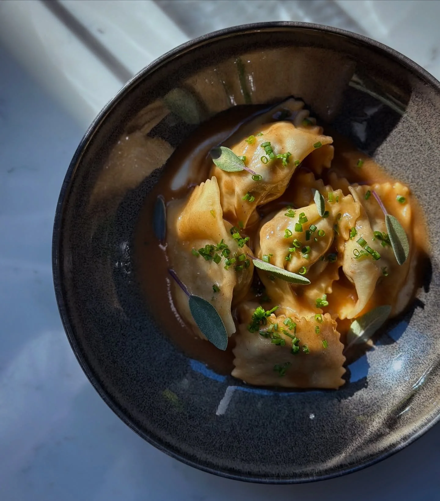 Never too late to change your dinner plans 👀 The plate of the moment? Housemade agnolotti filled with braised short rib and porcini mushrooms and served over boujie cheese sauce top with sage fresh from @plantainsupernova_ &lsquo;s herb garden. 😋🥟