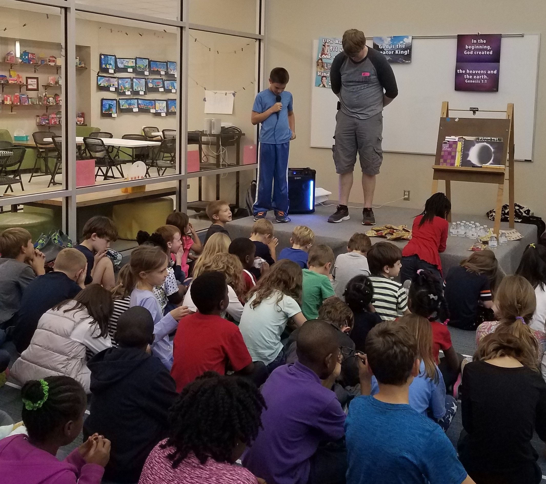 Matt Burkhart of The Church @ Pike Road and a student lead the opening prayer at Pike Road Good Elementary Good News Club® .
