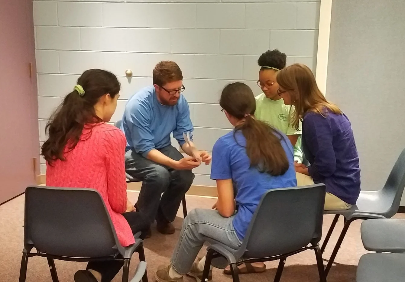 Kelley Herring joins the Young Meadows Presbyterian Summer team in prayer at the annual Summer Church Training.
