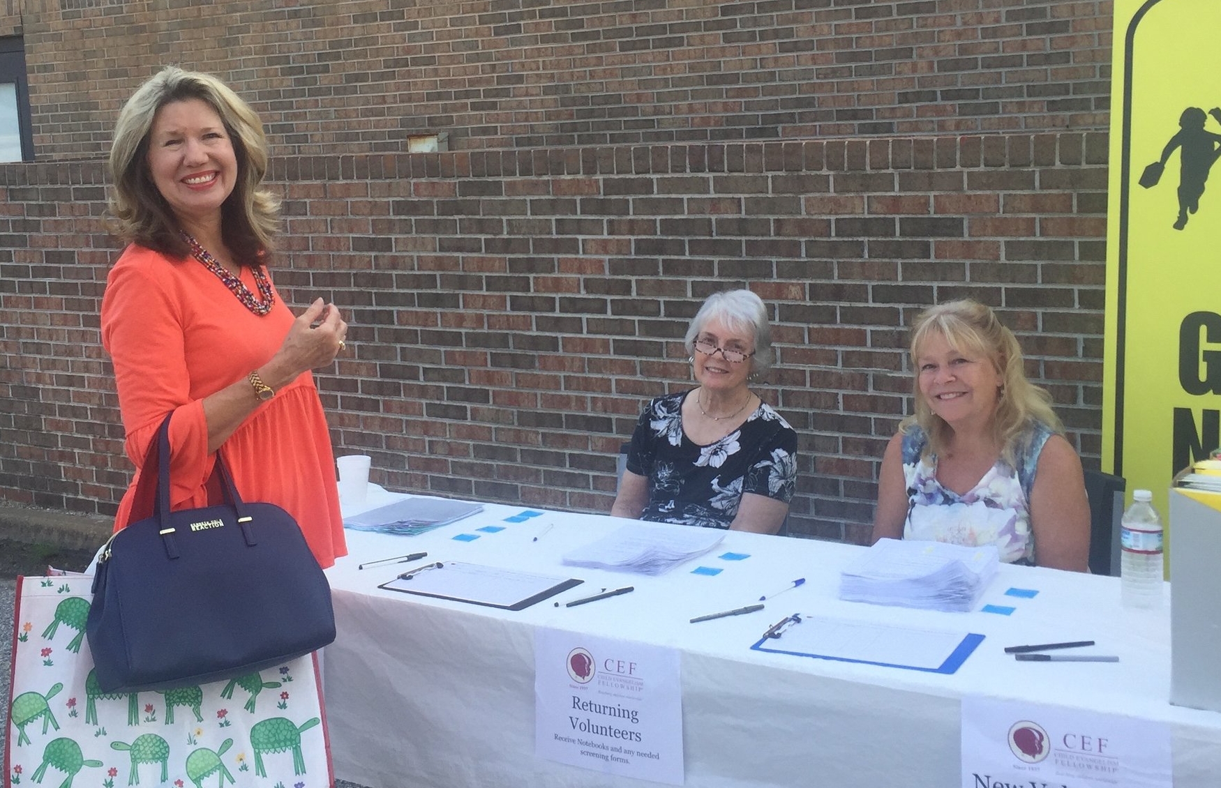  Linda Brown (far left) welcomes and registers volunteers at the annual  Good News Club®  Training. 