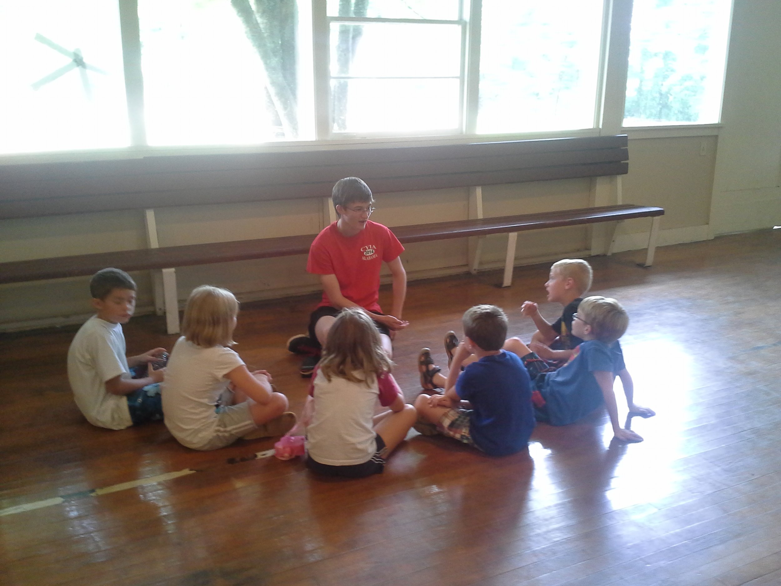Andy Russell counsels children after a Bible lesson at a Camp Grandview 5-Day Club® in Wetumpka, Alabama.