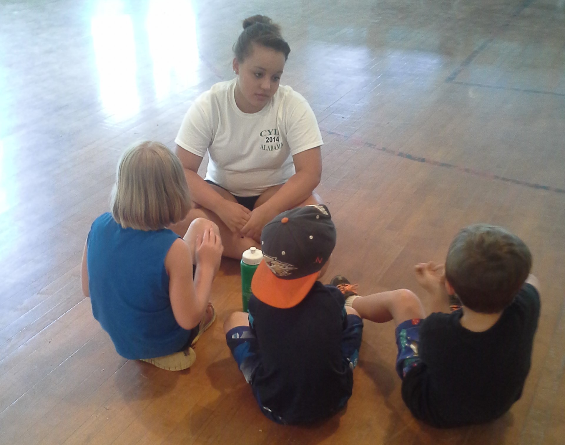  Jade Marcum counsels children after the Bible lesson at a Camp Grandview  5-Day Club®  in Wetumpka, Alabama.    