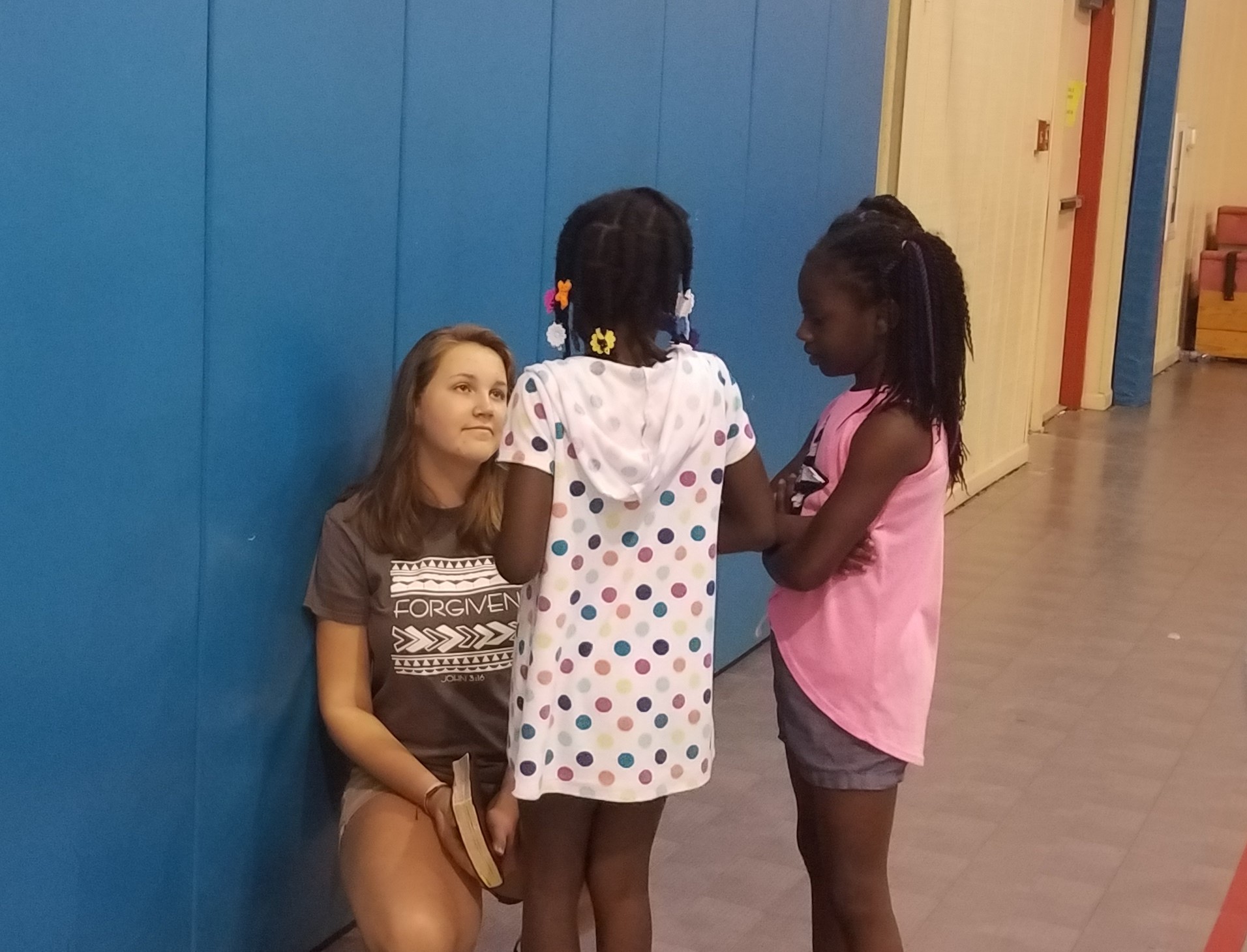 Kate Carver counsels girls after a Bible lesson at a  5-Day Club®  at the Bell Road Good Times Center in Montgomery, Alabama .   
