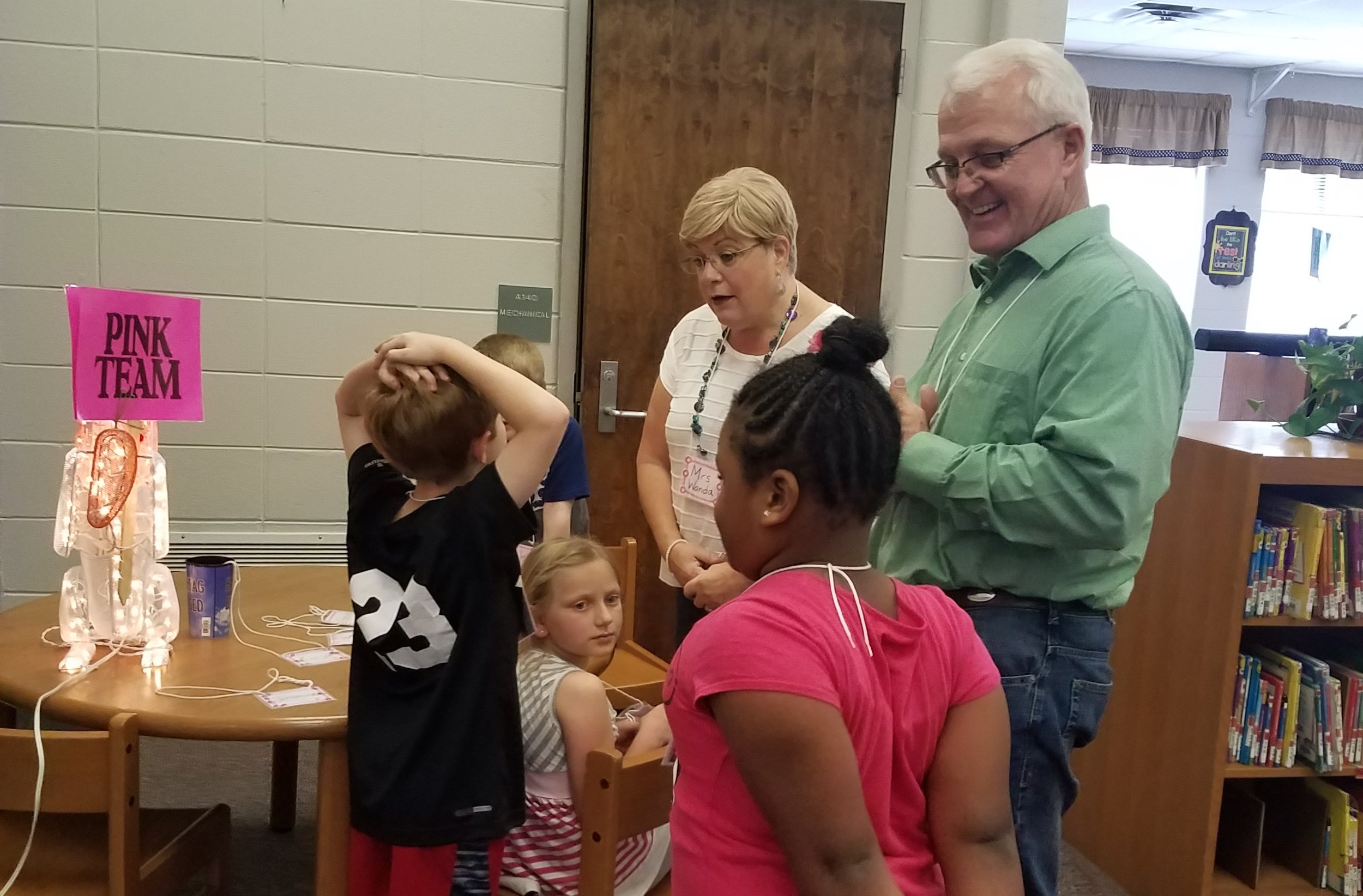  Volunteers welcome children to  Good News Club®  at Coosada Elementary.    