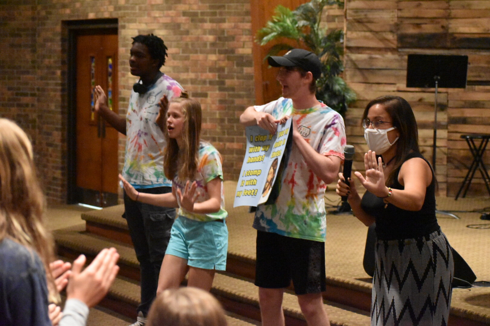  Silas Jones, Grace DuPre, and Naomi Kemp show the moves to the 7MIT song as Micah Brown flips the visual for the children at a church 5-day club in June 2020! 
