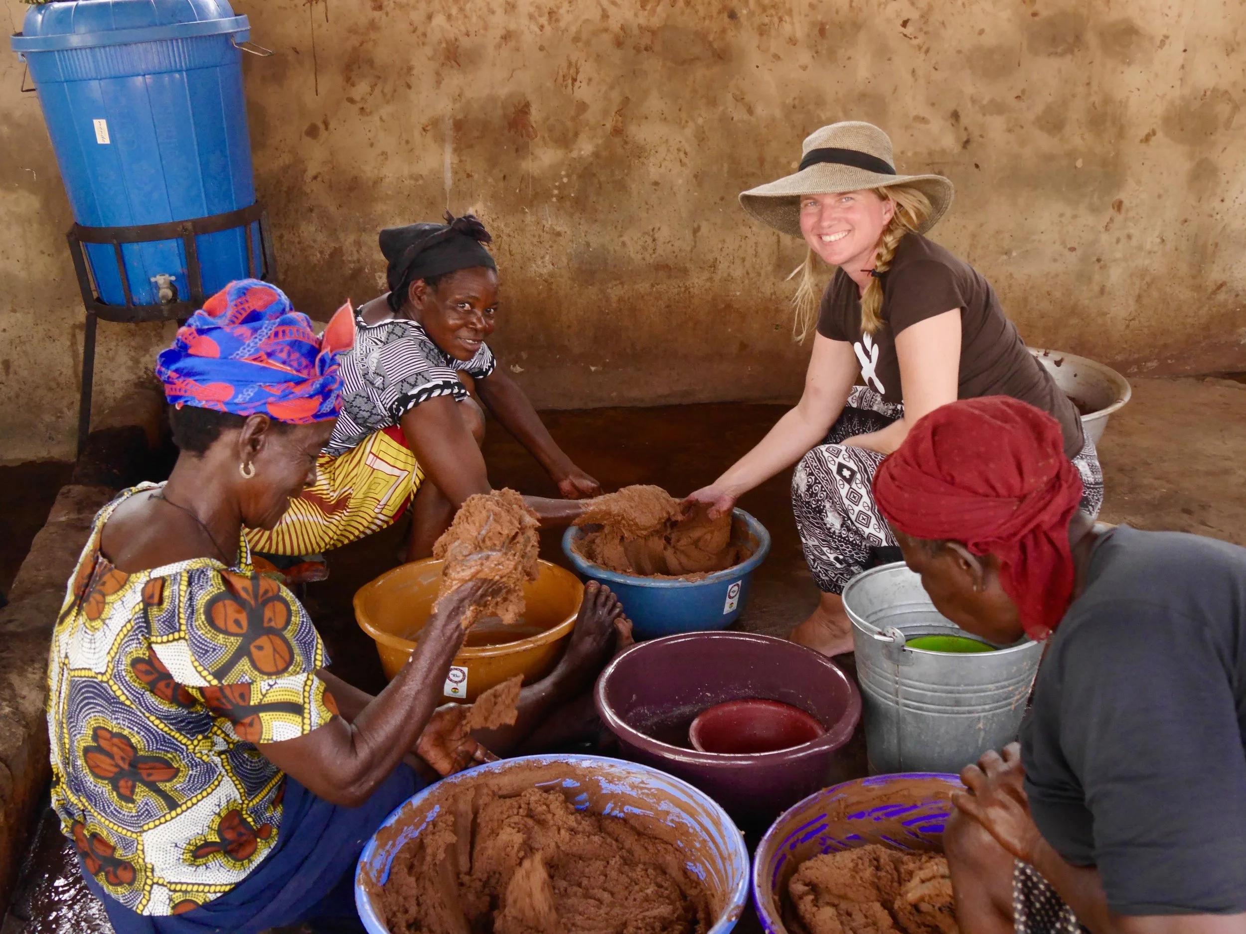 Taking part in the kneading of the shea butter. One part in the two day long preparation process.