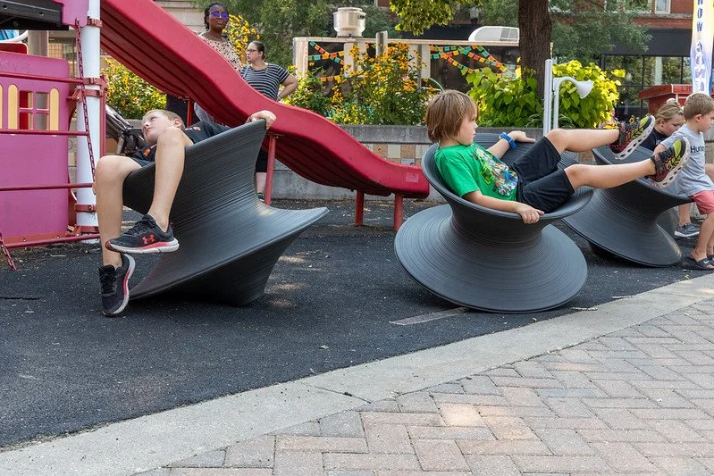 spin chairs in town square downtown grand forks