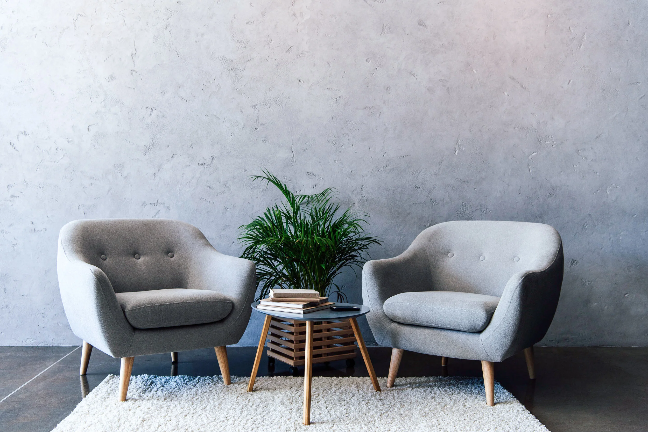 Two gray armchairs table and plant.jpg