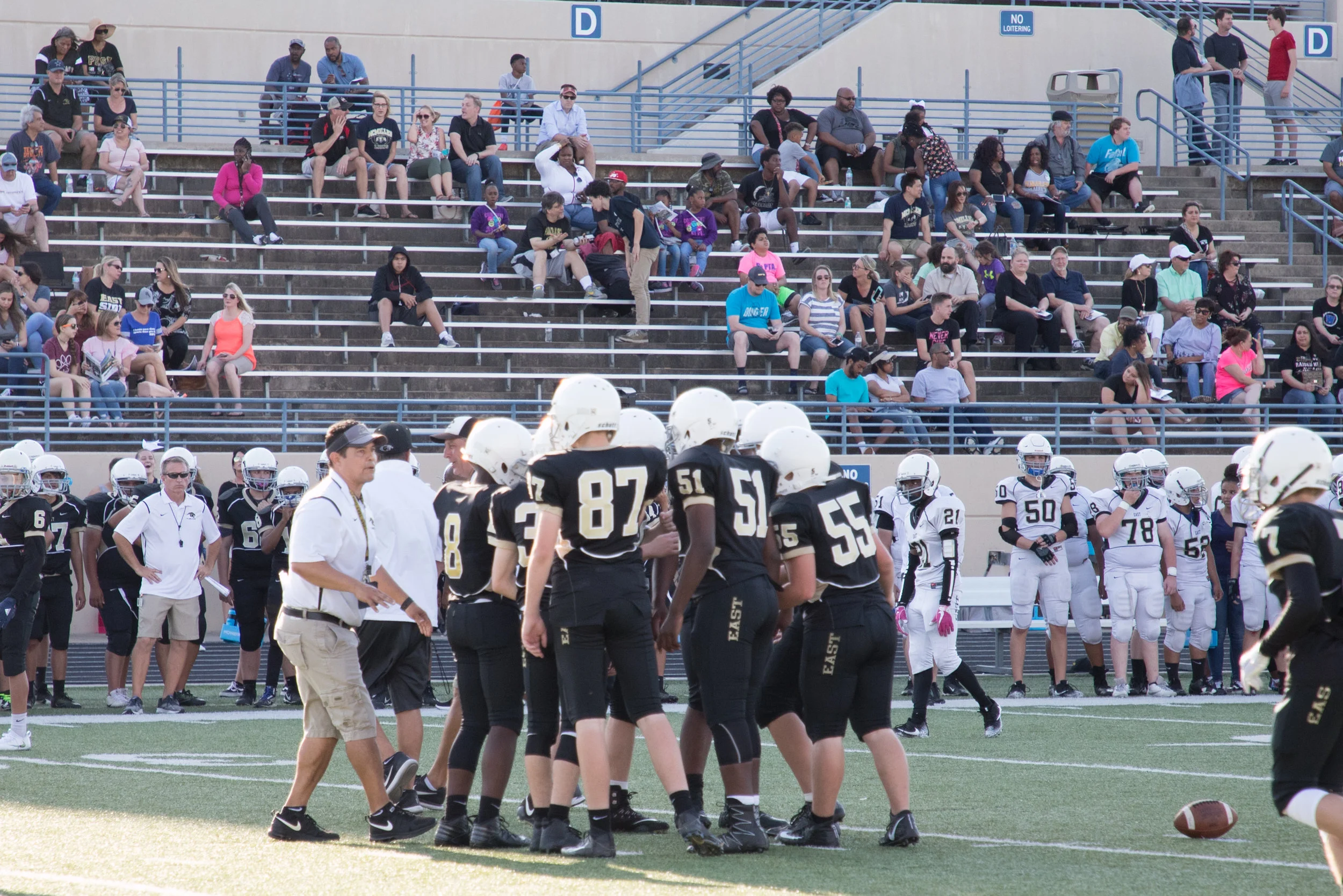 2-Coach Martinez huddles the players before a play.jpg