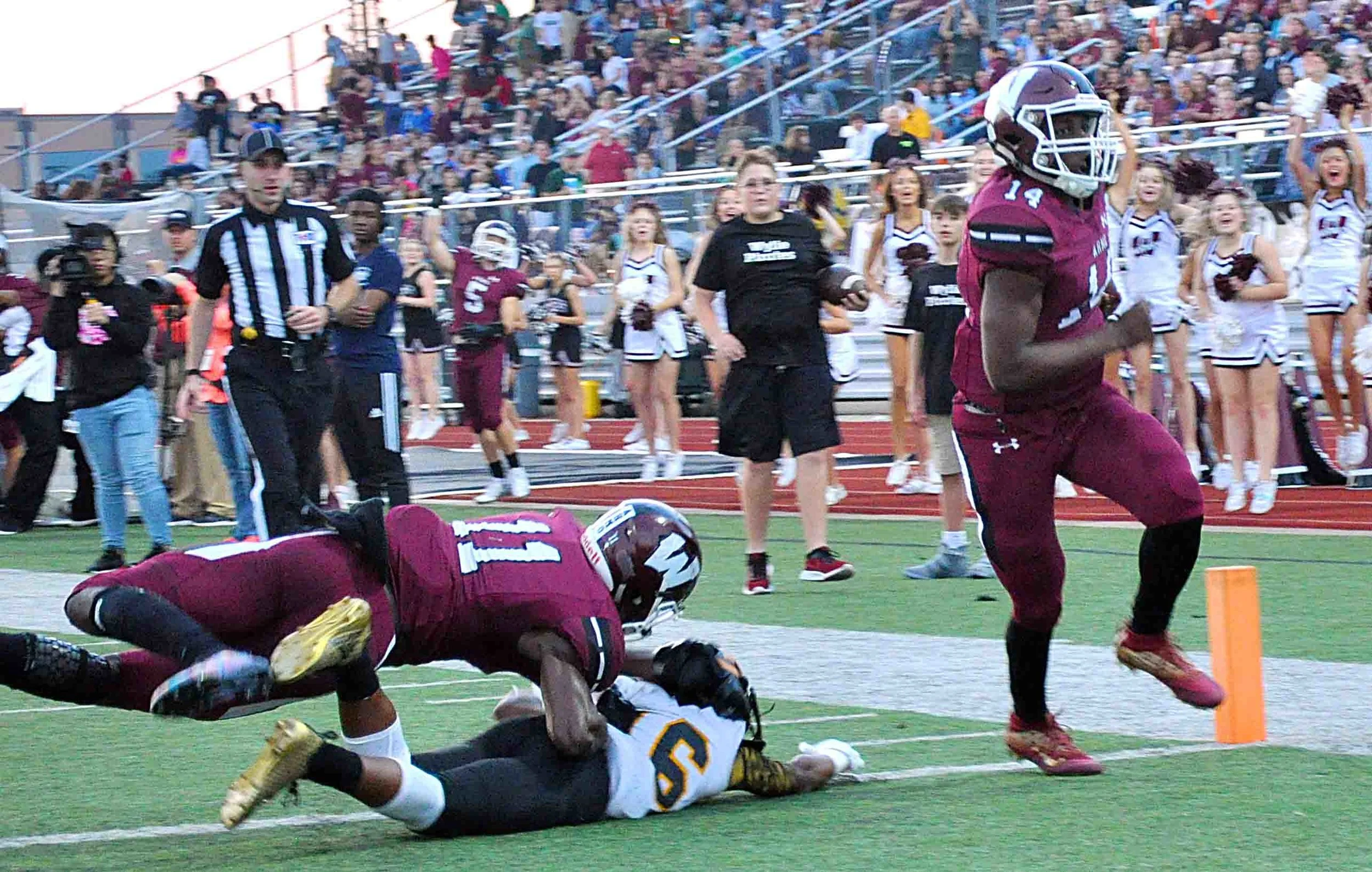Pirates #11 Donovan Ollie tackles Garland #16 as #14 Rashad Dixon scores.
