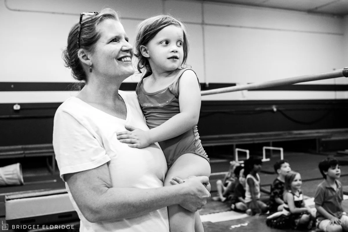 girl takes a break from party to snuggle with mom