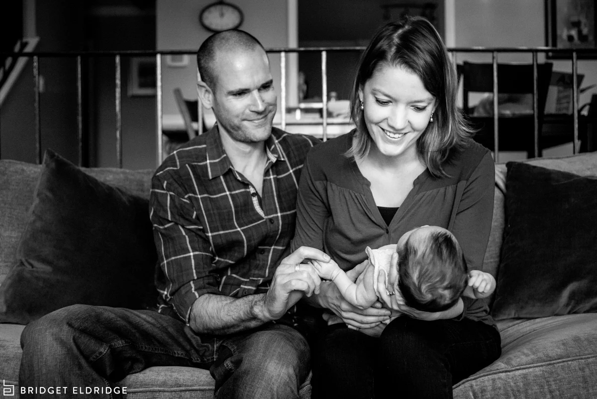parents hold newborn daughter