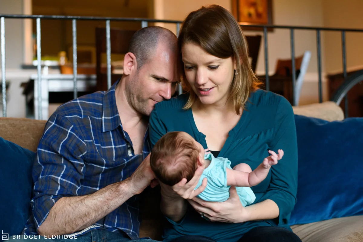 northern virginia parents snuggle with newborn daughter