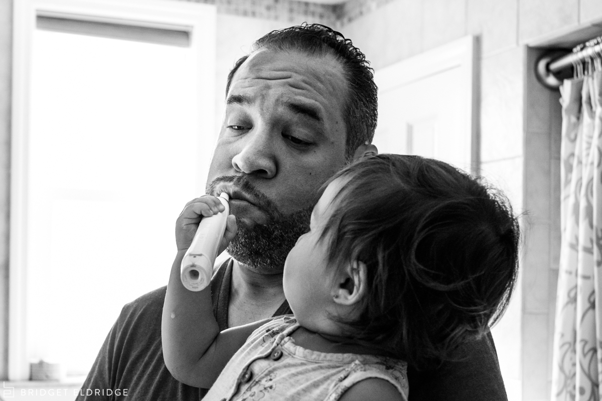 daughter brushes her dad's teeth