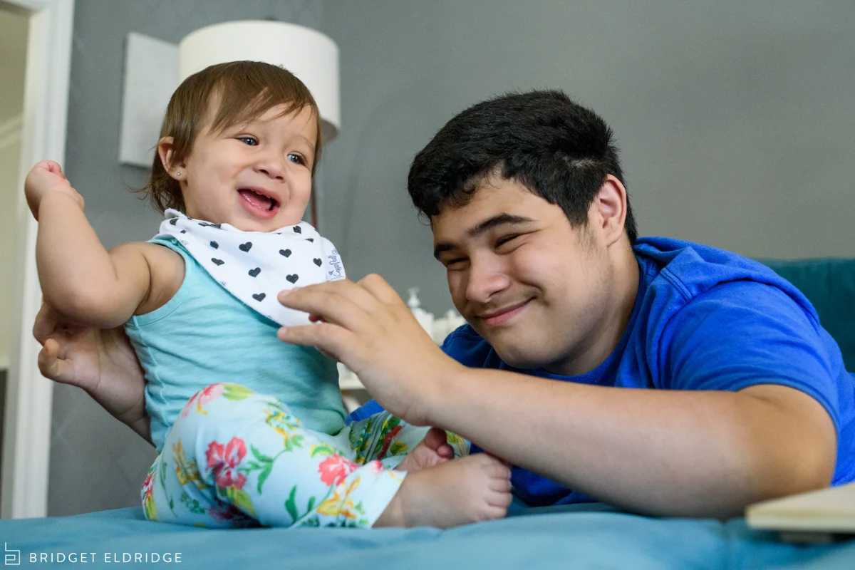 big brother tickles his little sister