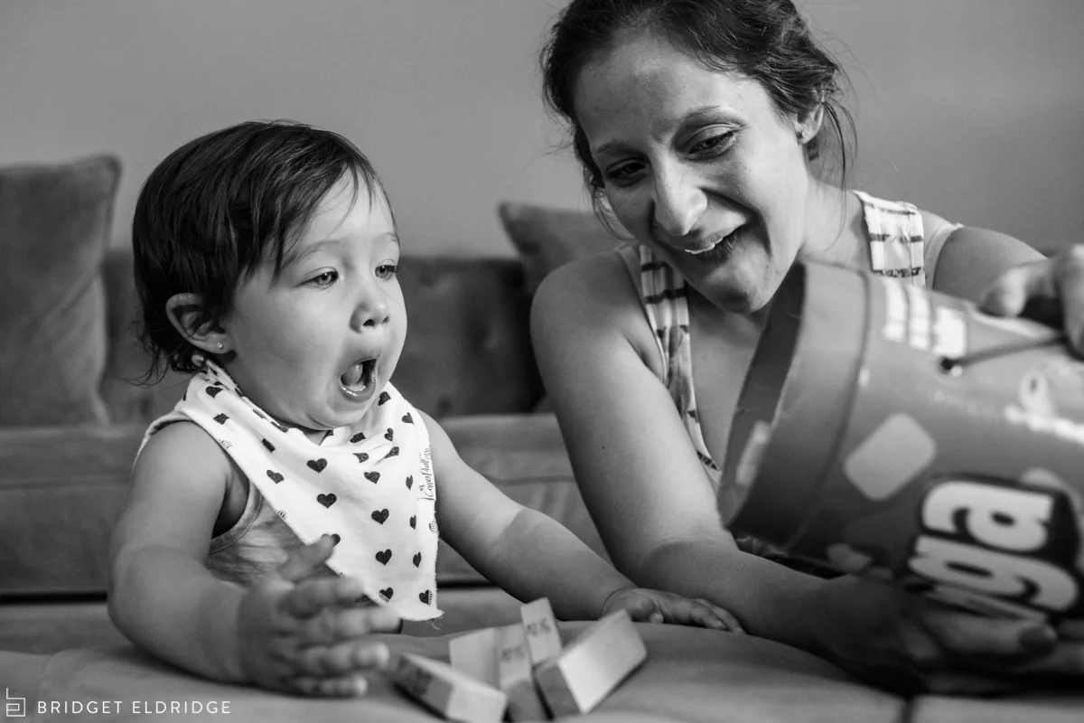 baby is surprised by the jenga blocks