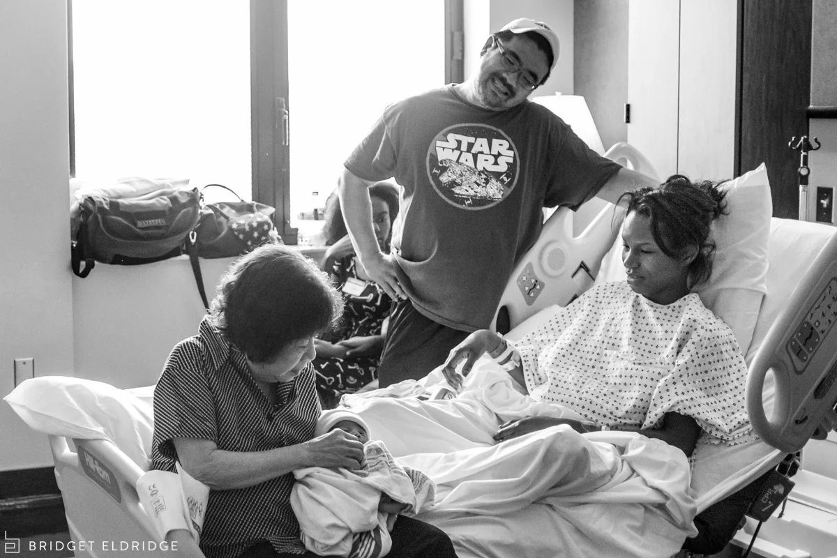 parents look on as grandmother holds her grandson at reston hospital center