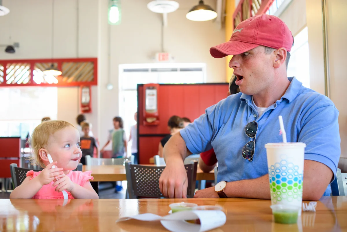 dad and daughter wait for food at district taco in old town